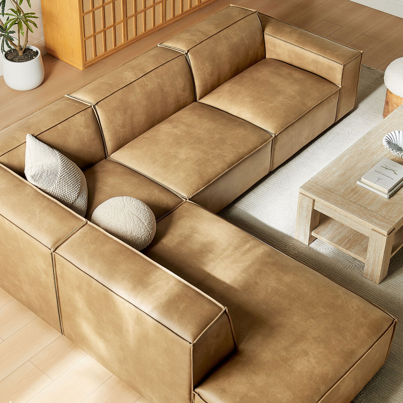Modular sectional with left chaise and accent pillows, paired with a light wood coffee table and rug || EEI-7432-TST || top_angle_room