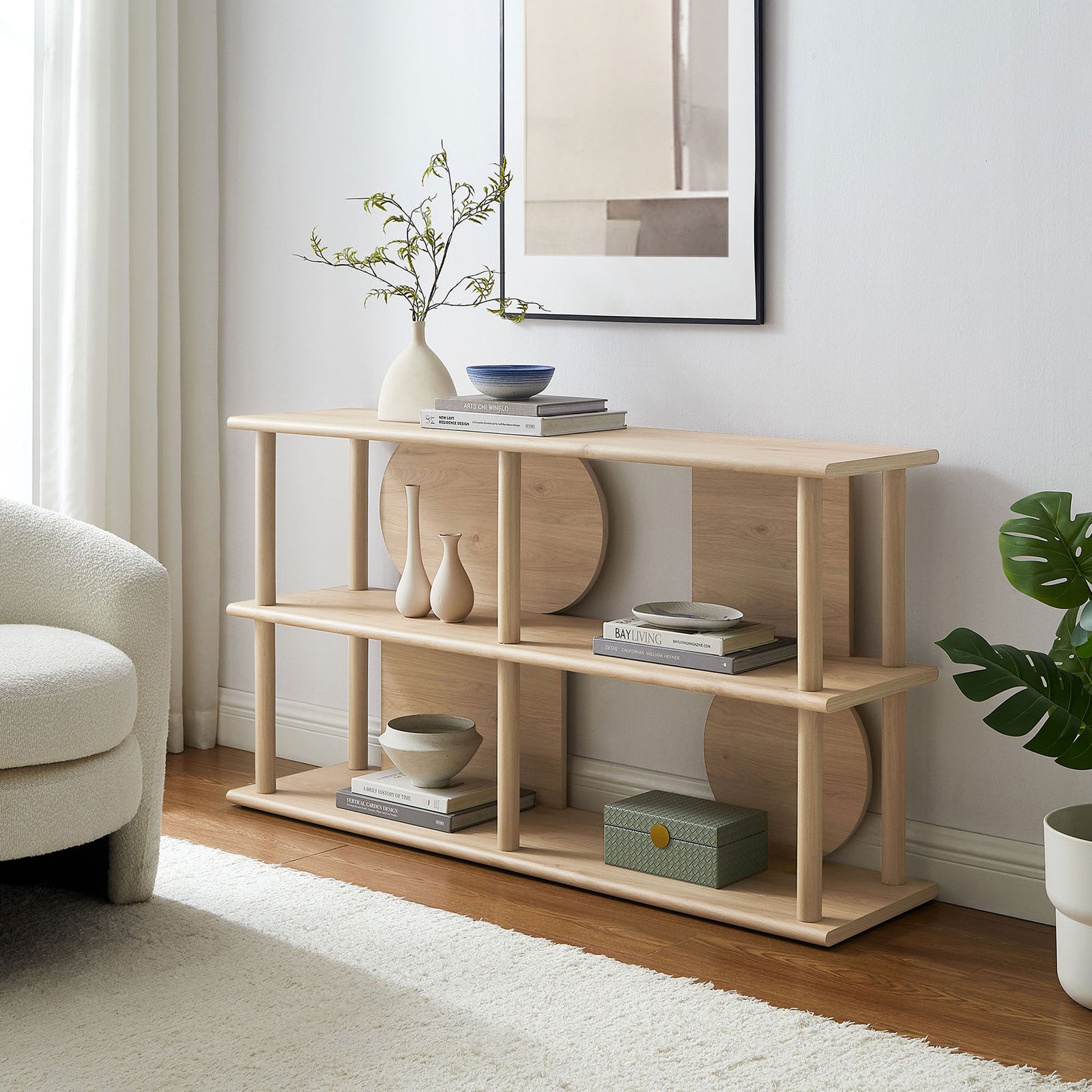 Style-ready console table adds sculptural storage and display space in a bright modern living room || EEI-7433-LOA || front_angle_room