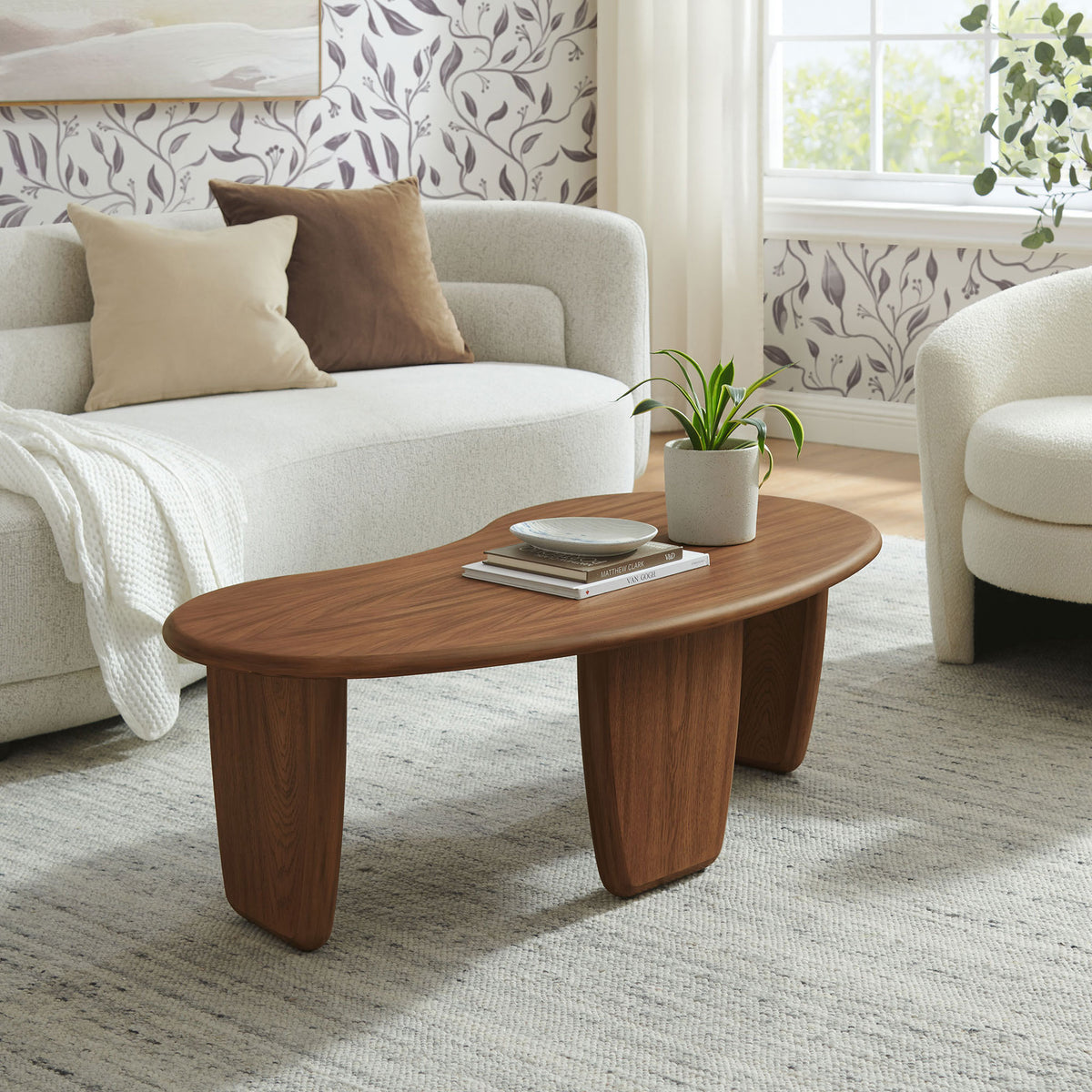 Kidney-shaped coffee table brings mid-century warmth to a cozy living room setting || EEI-7437-WAL || front_angle_room