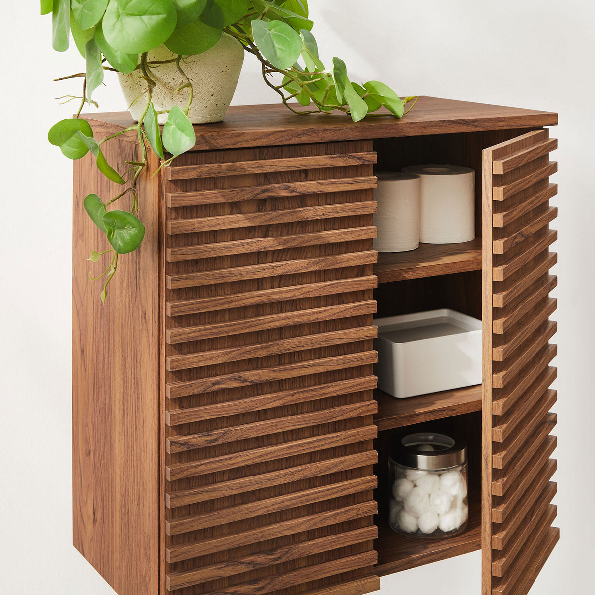 Wall-mounted cabinet neatly displays bathroom essentials while keeping clutter out of sight. || EEI-7438-WAL || front_open_room