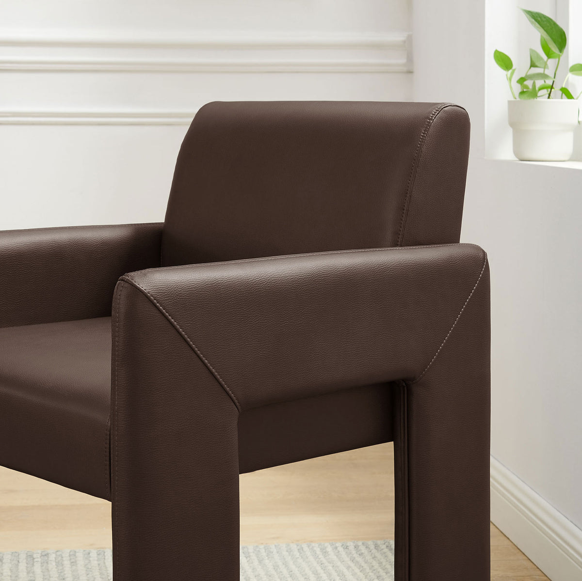 Espresso vegan leather armchair bringing soft curves and padded comfort to a bright contemporary room. || EEI-7443-ESP || detail_room