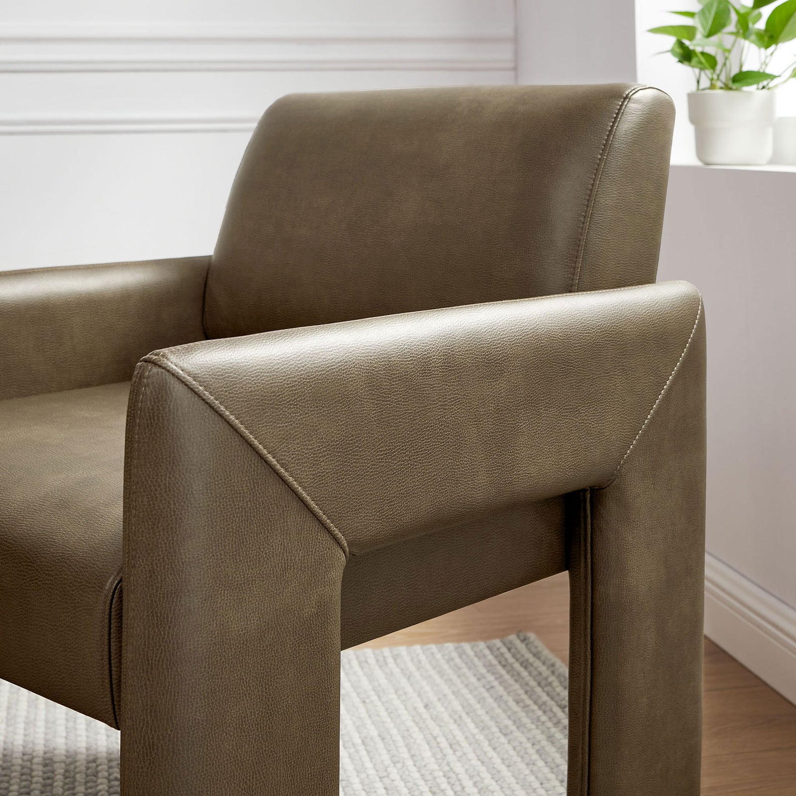 Mushroom vegan leather armchair back and armrest with smooth finish styled by a bright window || EEI-7443-MUS || detail_room