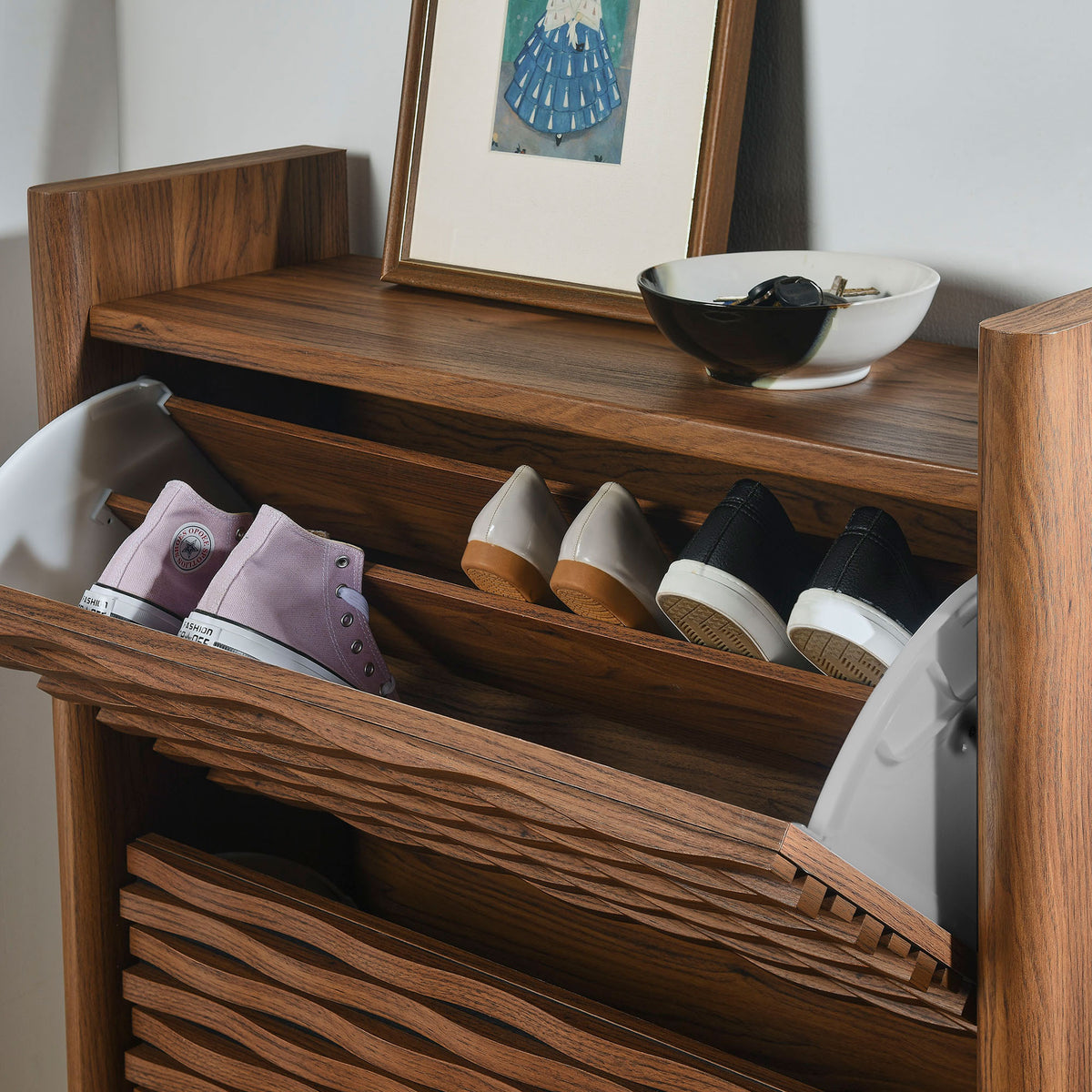 Shoe cabinet in use with sneakers and heels stored neatly in the flip down compartments in an entryway || EEI-7447-WAL || front_angle_open_room