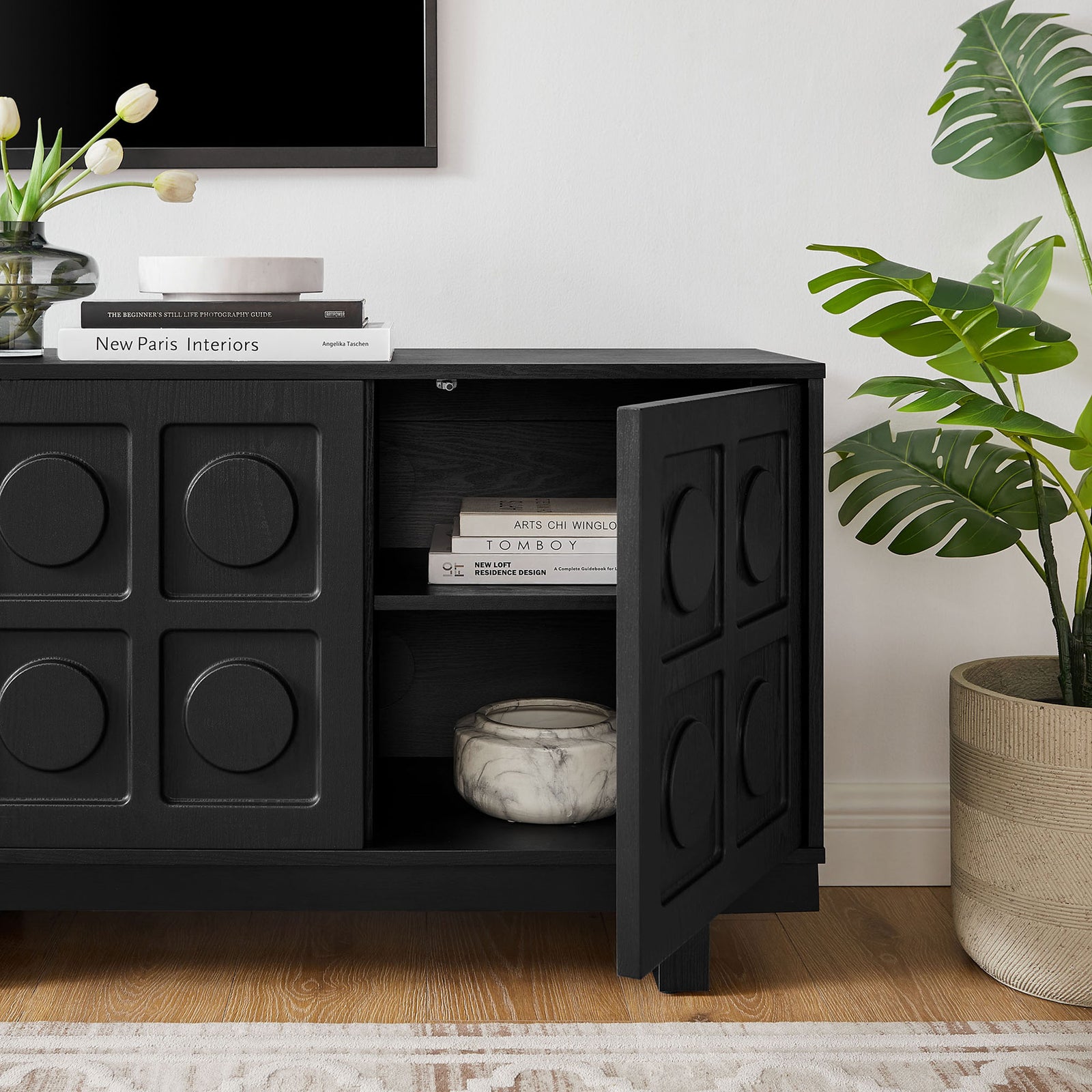 Black Knox TV stand in a bright living room with one door open to reveal neatly styled storage || EEI-7450-BLK || storage_open_room