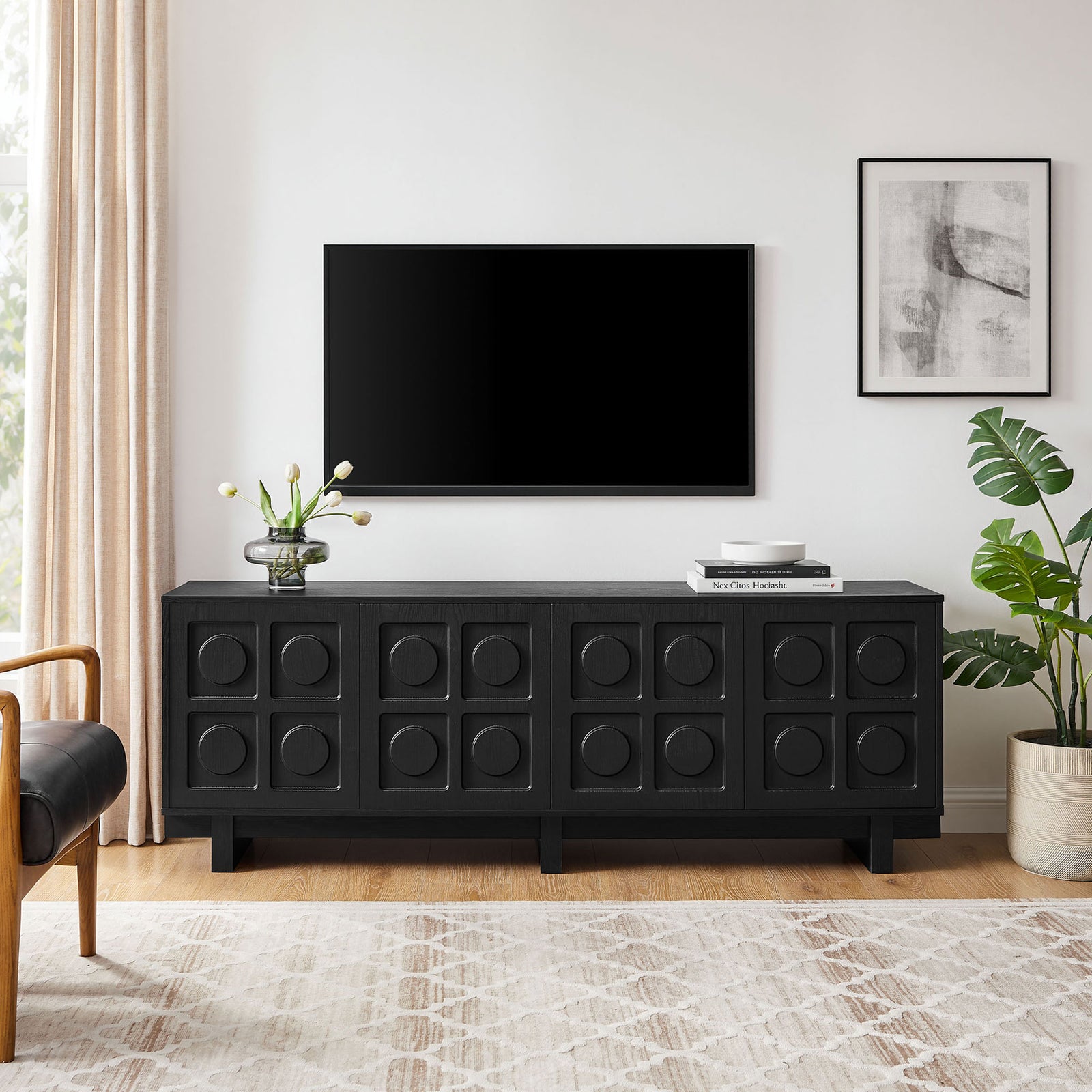 Black Knox TV stand centered under a wall mounted TV with plants and decor for a clean media setup || EEI-7450-BLK || front_room