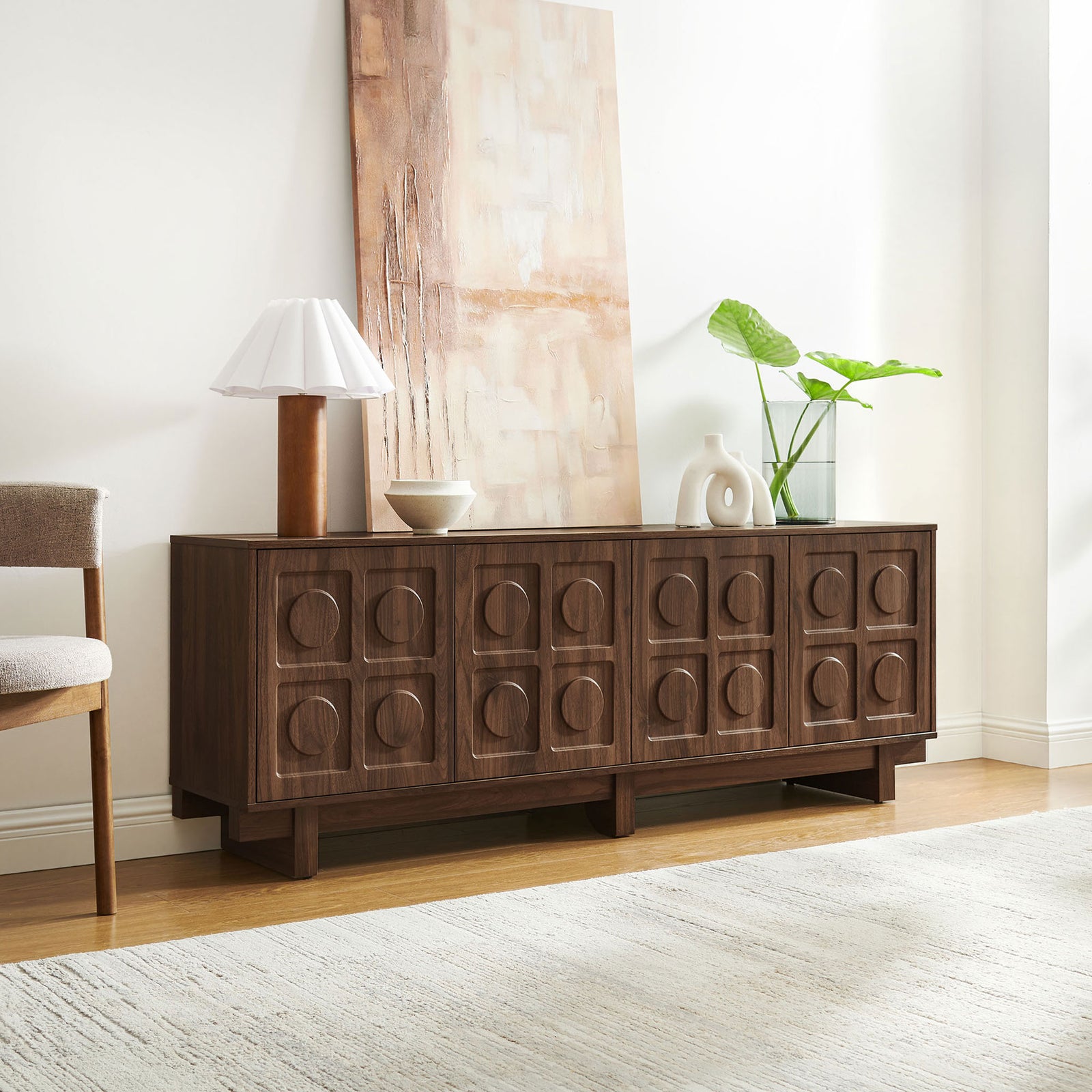 Walnut Knox TV stand styled as a sideboard with artwork, lamp, and ceramic vases in a serene room || EEI-7450-WAL || front_angle_room