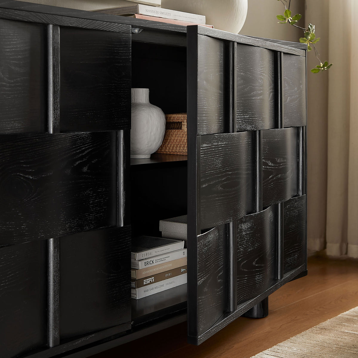 Black woven-front buffet styled with decor and books, showing convenient interior storage space || EEI-7452-BLK || front_angle_open_room