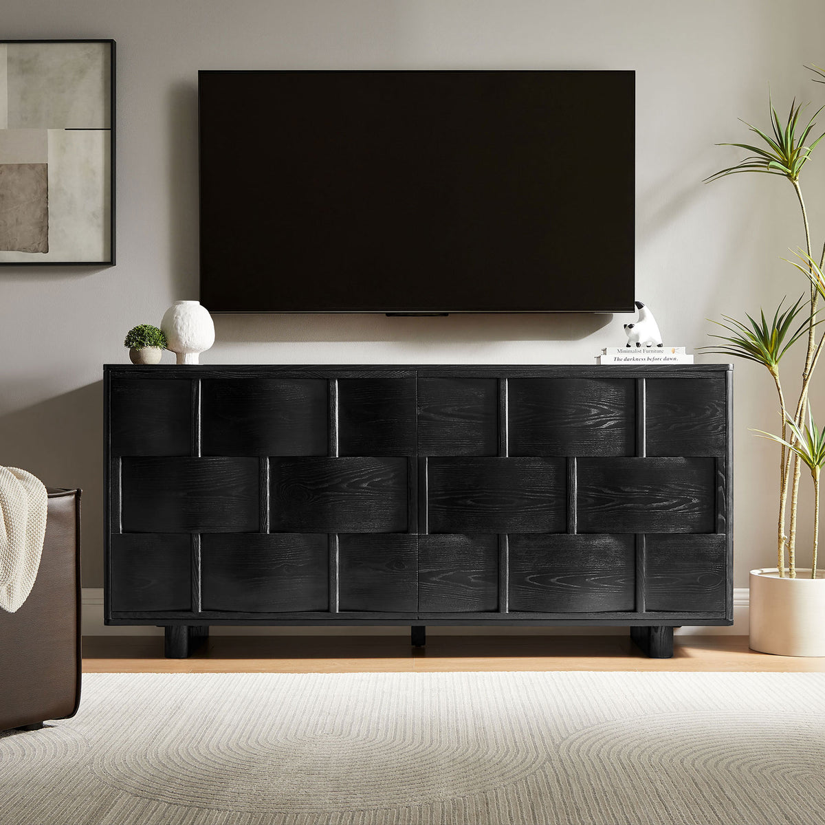 Black woven buffet cabinet used as a media console beneath a wall-mounted television || EEI-7452-BLK || front_room