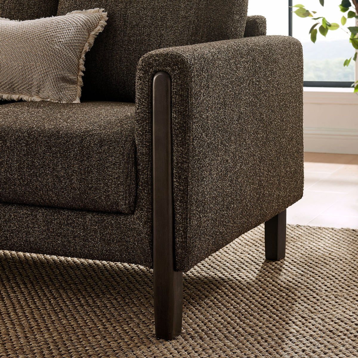 Antique espresso boucle armrest framed by a rounded solid wood leg in a warm, layered living space || EEI-7461-ATQ-ESP || leg_room