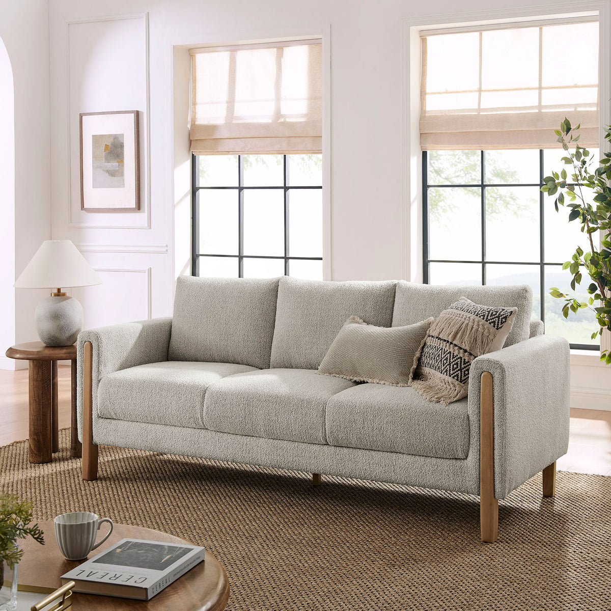 Hawken boucle sofa styled in a bright living room with cozy pillows and warm wood accents || EEI-7461-PCH-BEE || front_angle_room