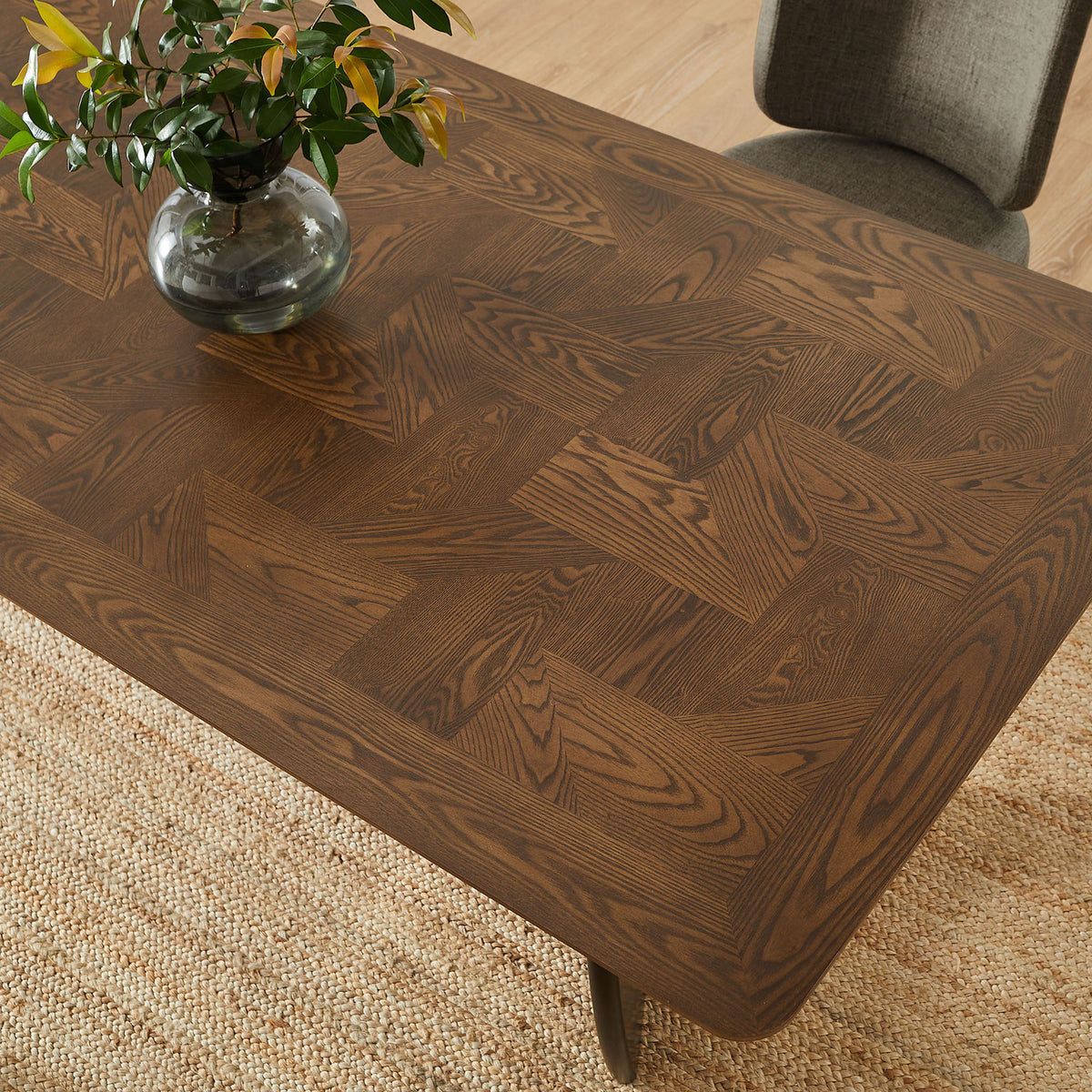 Walnut tabletop brings warmth and pattern to the dining room, paired with soft upholstered chairs and greenery. || EEI-7462-WAL || detail_room