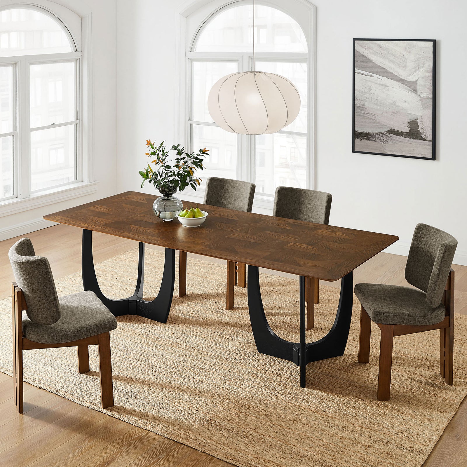 Wrenly walnut dining table styled in a bright dining room with coordinating chairs and neutral textured rug. || EEI-7462-WAL || front_angle_room