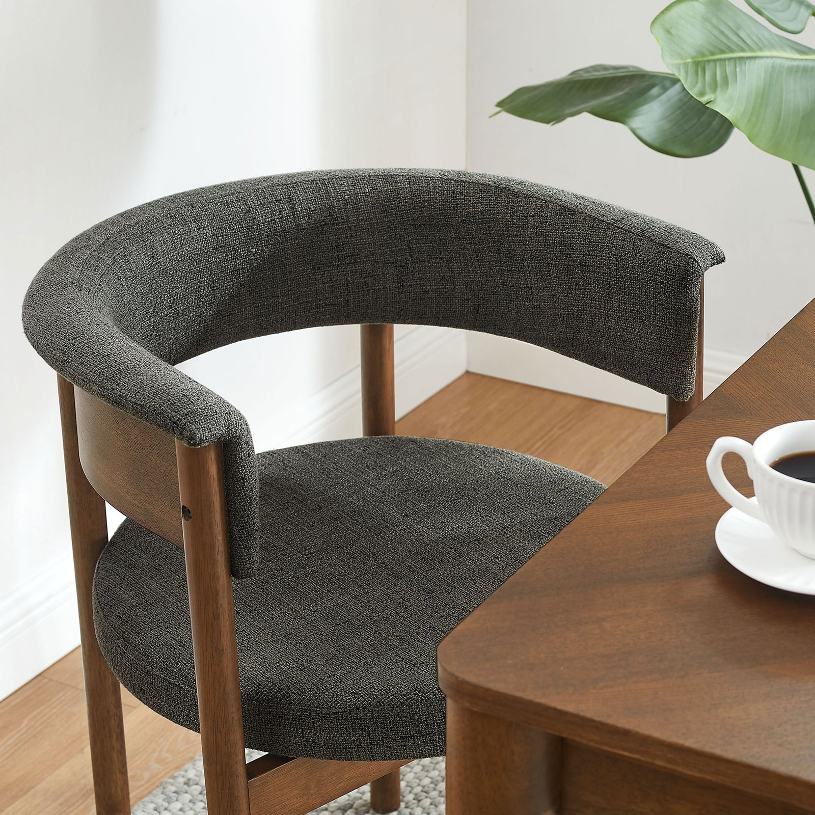 Charcoal curved dining chair styled at a wooden dining table, adding soft texture and warm wood tones to the room || EEI-7467-CHA || front_angle_room