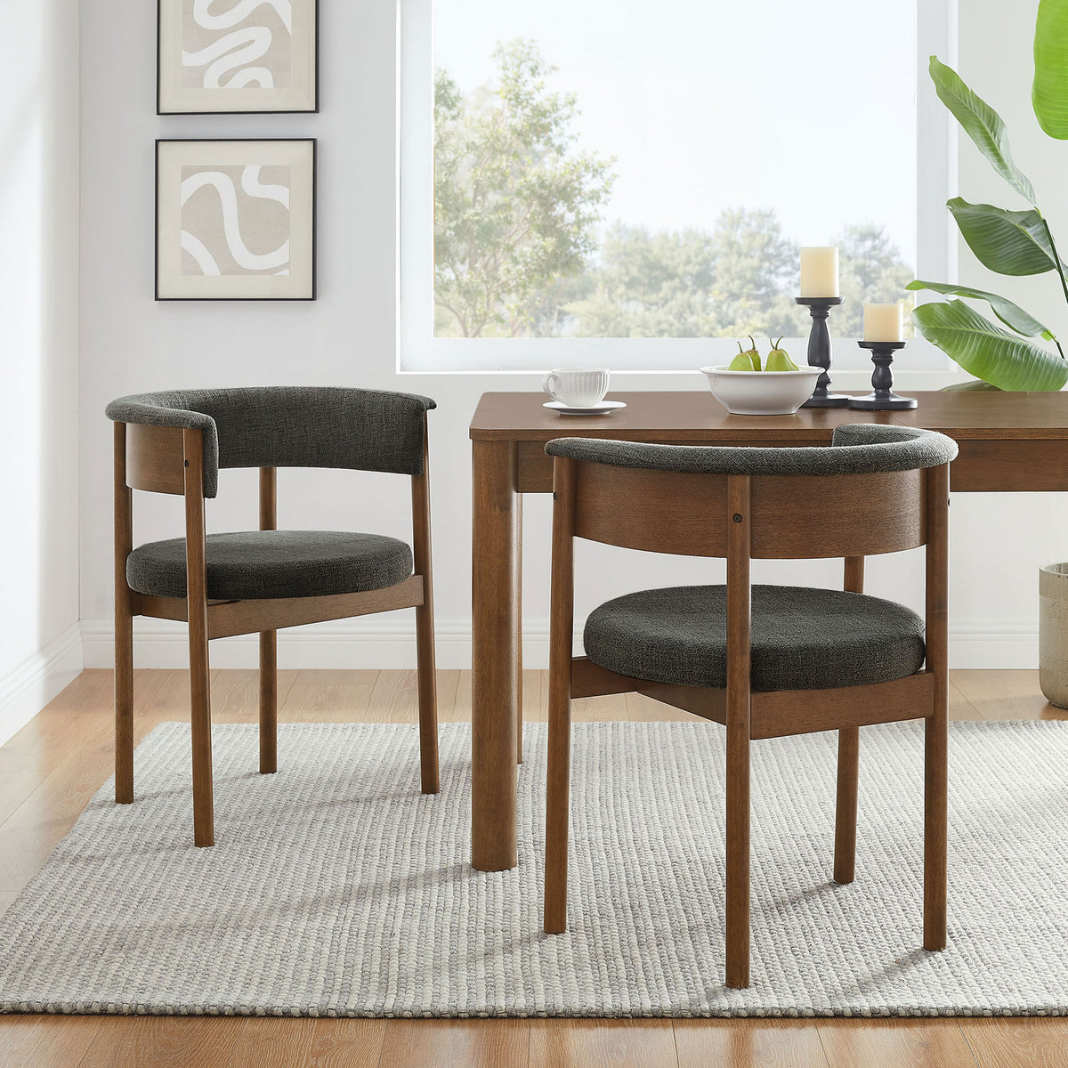 Pair of charcoal curved dining chairs around a wood table creating a cozy, modern dining space || EEI-7467-CHA || front_angle_multi_room