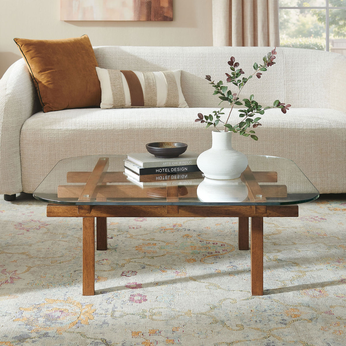 Modern coffee table pairs a clear tempered glass top with a walnut grid base in the living room || EEI-7468-WAL || front_angle_room