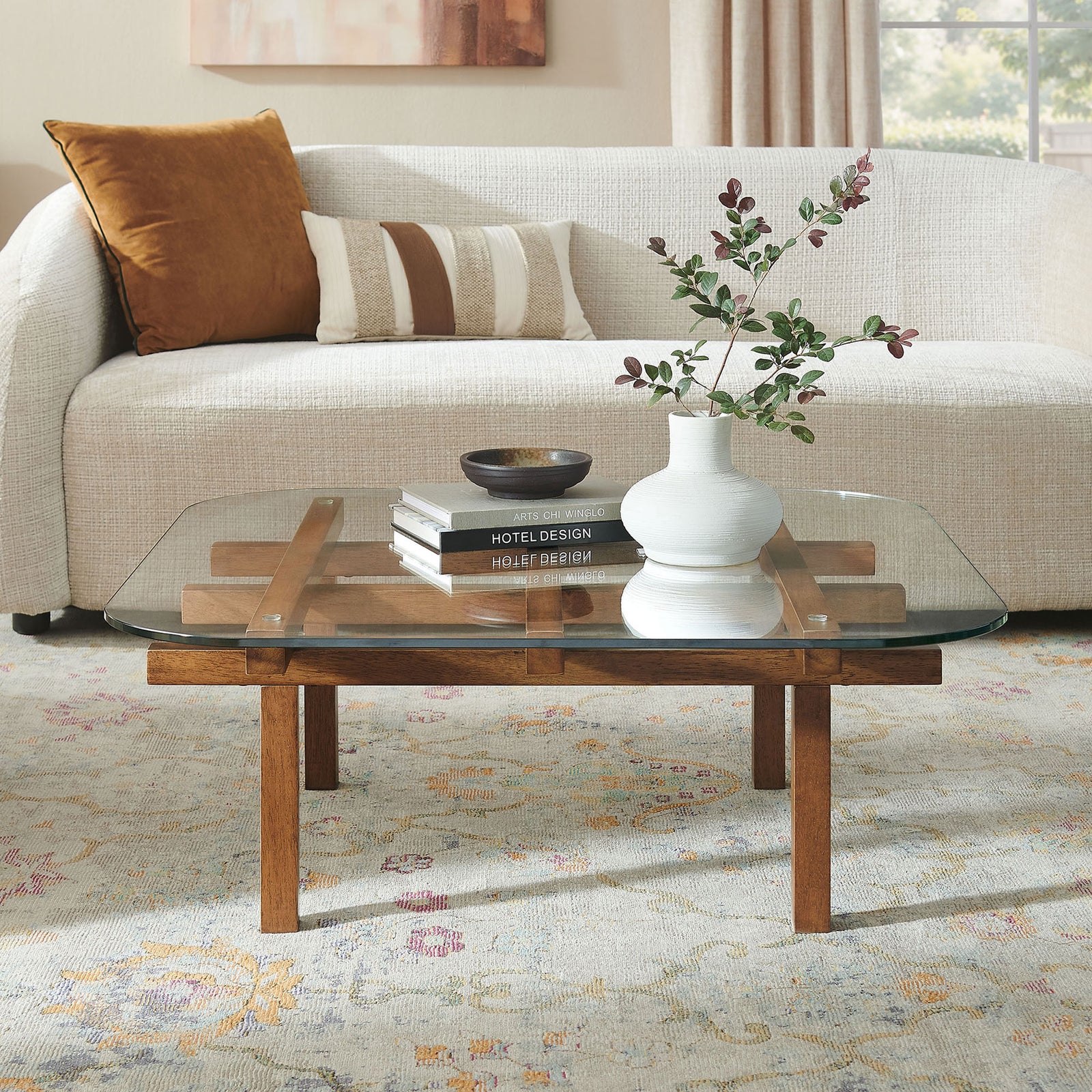 Modern coffee table pairs a clear tempered glass top with a walnut grid base in the living room || EEI-7468-WAL || front_angle_room