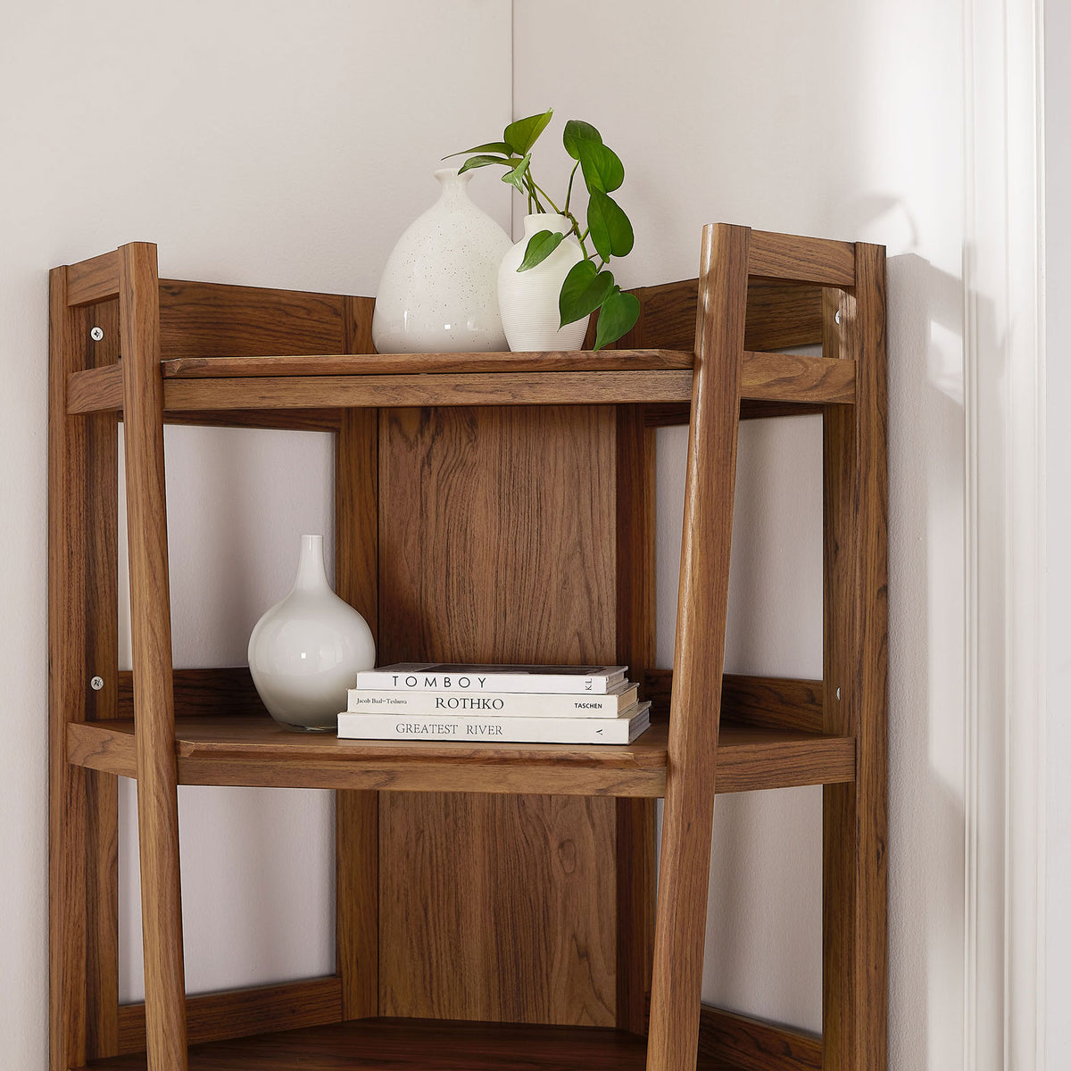 Walnut corner bookshelf styled with decor, showcasing open shelving and airy window-style panels || EEI-7469-WAL || detail_room