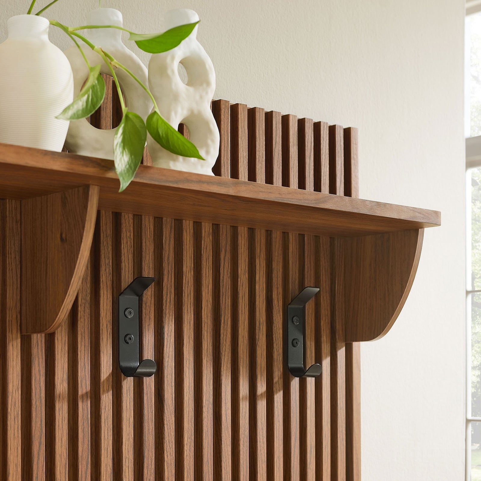 Curved shelf brackets and matte black hooks add contrast and everyday utility || EEI-7473-WAL || detail_room