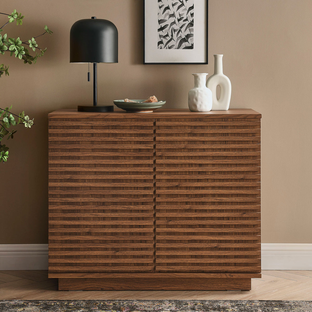 Walnut fluted accent cabinet styled with decor in a warm modern living room setting || EEI-7476-WAL || front_angle_room
