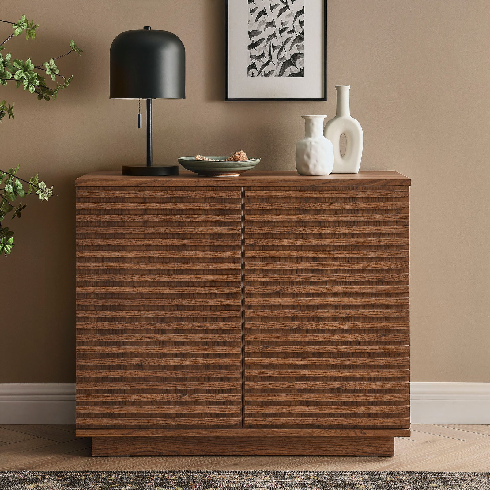 Walnut fluted accent cabinet styled with decor in a warm modern living room setting || EEI-7476-WAL || front_angle_room