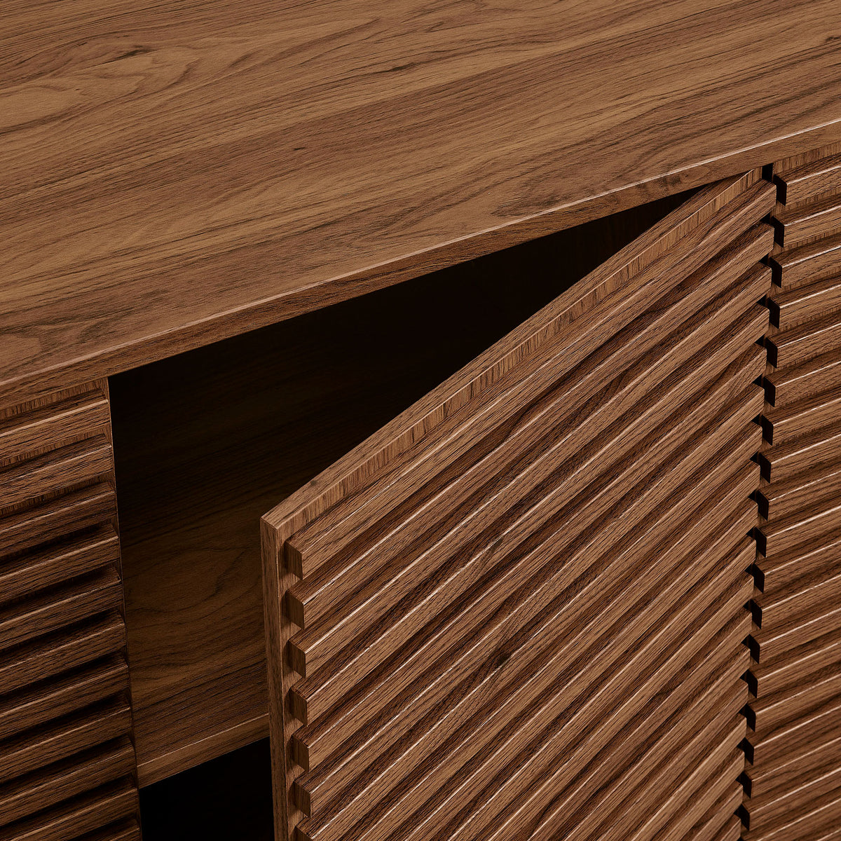 Detail of the fluted walnut door and top surface highlighting the textured slats and seamless push-to-open design || EEI-7477-WAL || detail_studio
