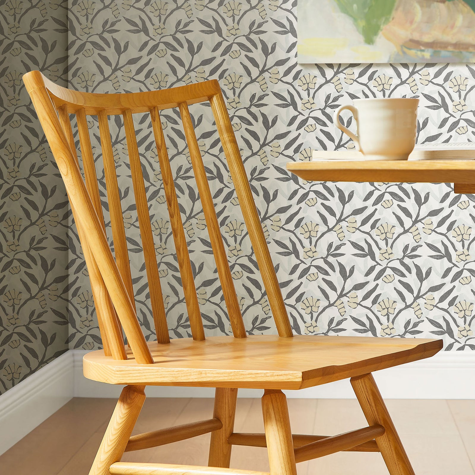 Ash wood spindle back dining chair styled beside a round table, adding warmth to a patterned dining space. || EEI-7482-ASH || detail_room