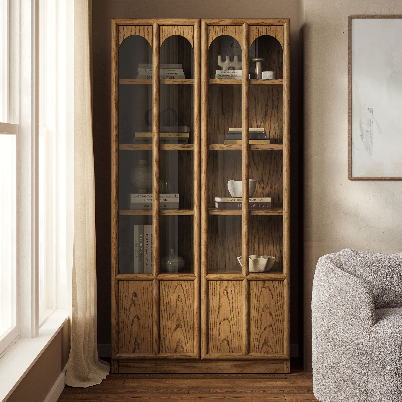 Oak Anwen display cabinet styled in a modern living space, showcasing decor behind clear glass doors || EEI-7484-OAK || front_angle_room