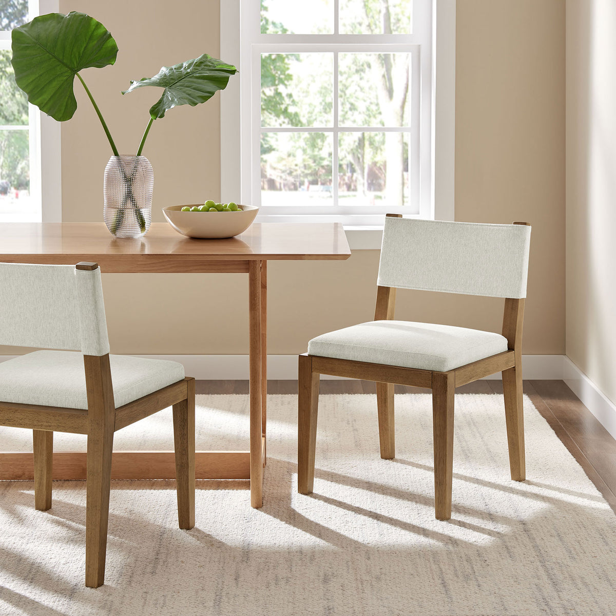Ivory dining chair styled with wood table to create a warm, inviting modern dining room || EEI-7485-HEI || front_angle_room