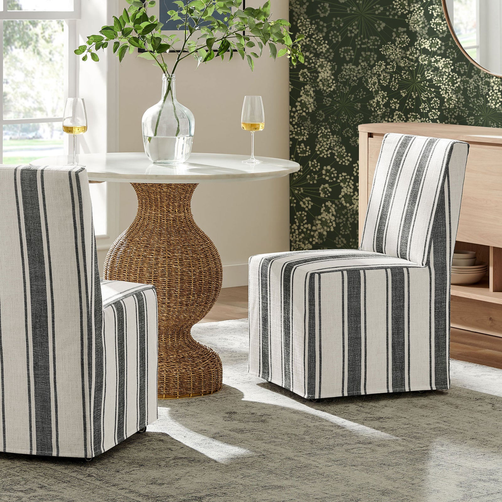 Pair of striped slipcovered dining chairs bringing relaxed elegance to a bright, inviting dining nook. || EEI-7486-BLK || front_angle_room