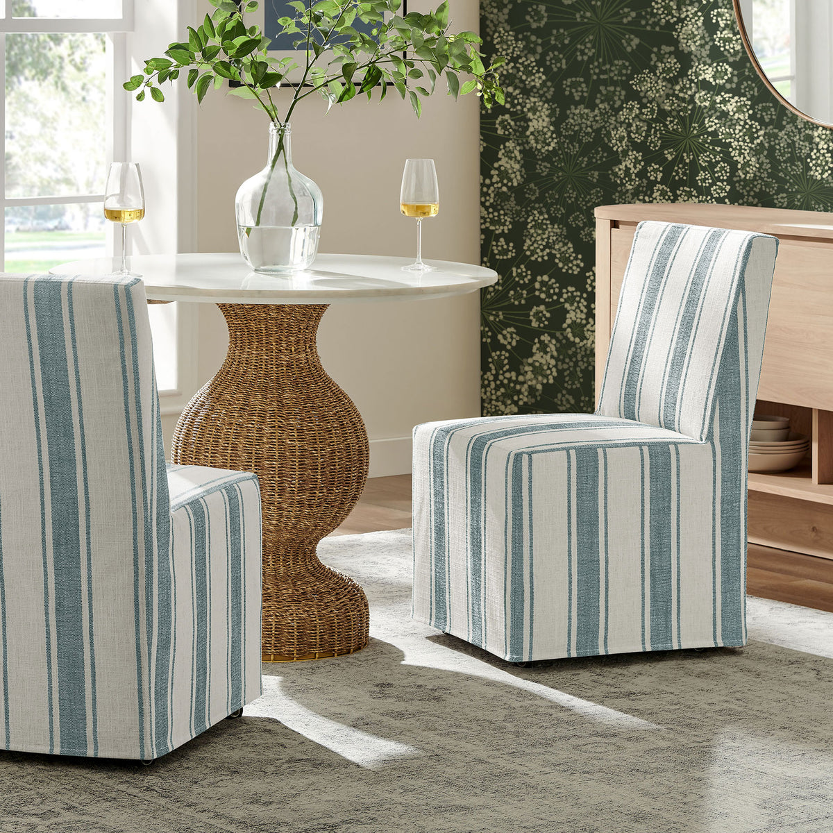 Pair of Tessera striped dining chairs creating a coastal-inspired look around a pedestal table || EEI-7486-BLU || front_room