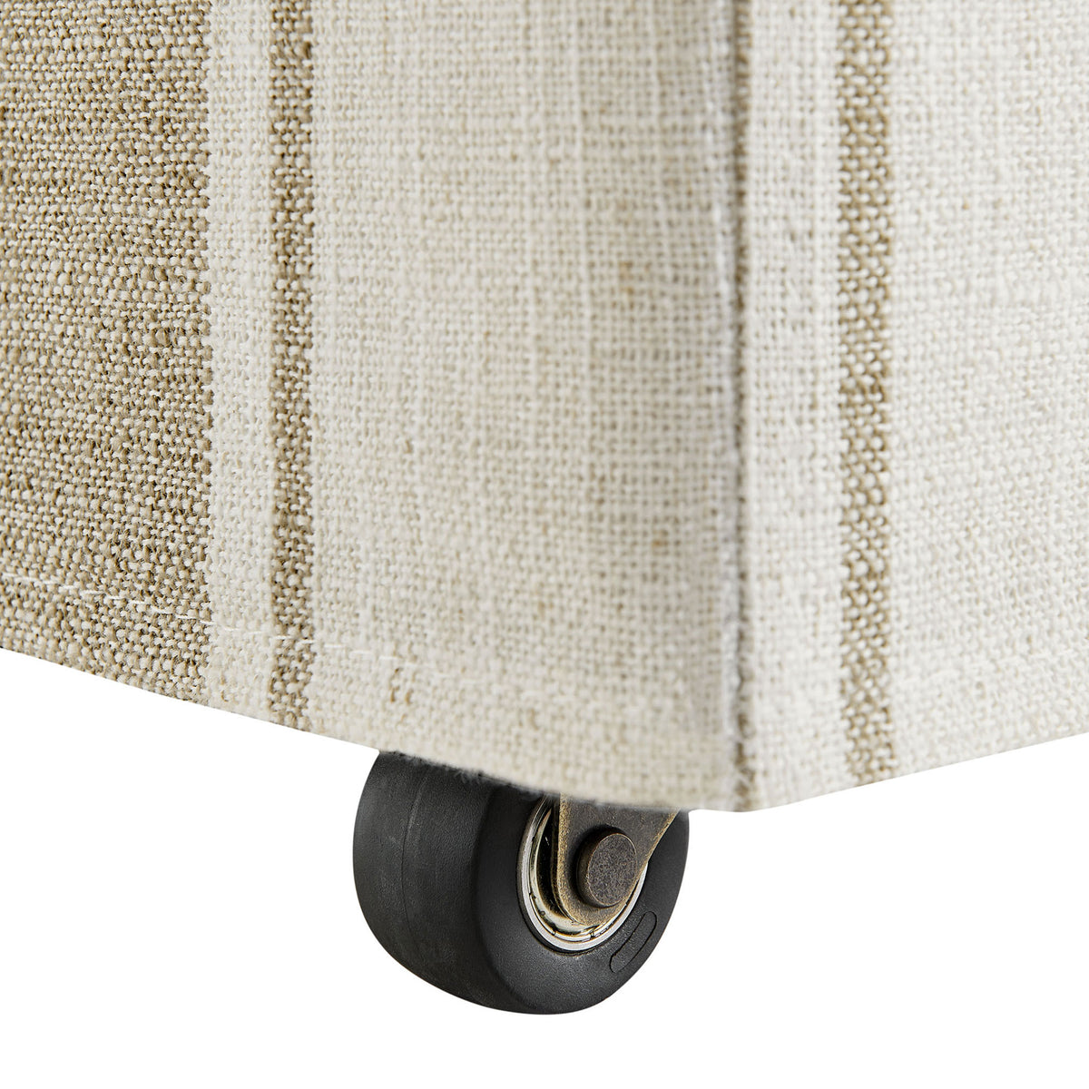 Hidden caster beneath the slipcovered base offers smooth mobility while maintaining a clean tailored look || EEI-7486-TAN || detail_studio