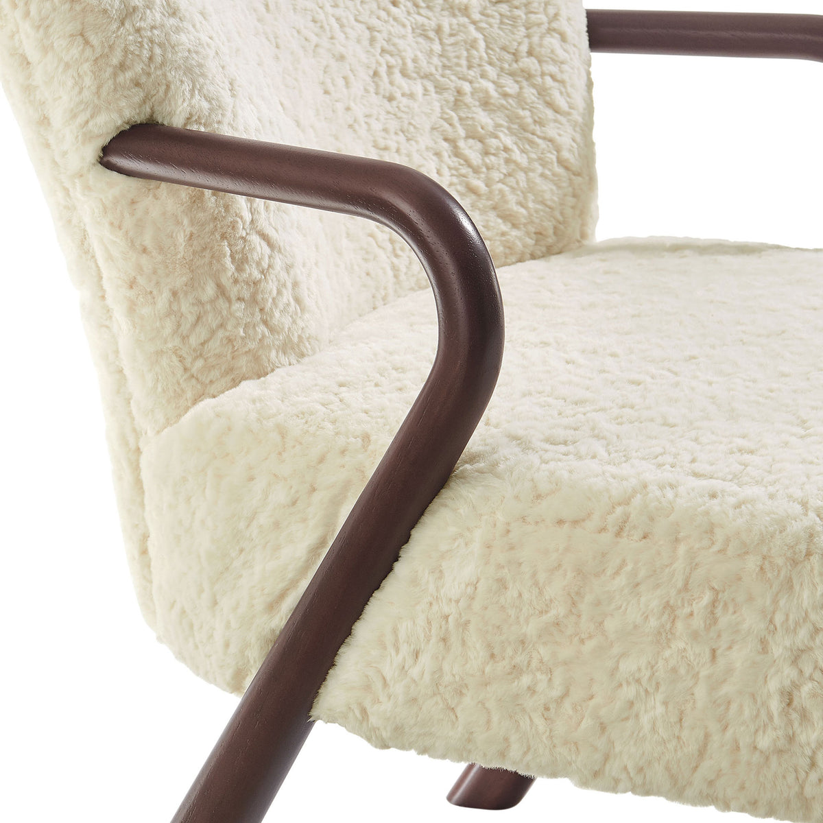 Rich contrast between smooth walnut-tone wood arms and plush faux shearling upholstery. || EEI-7489-ECR || detail_studio