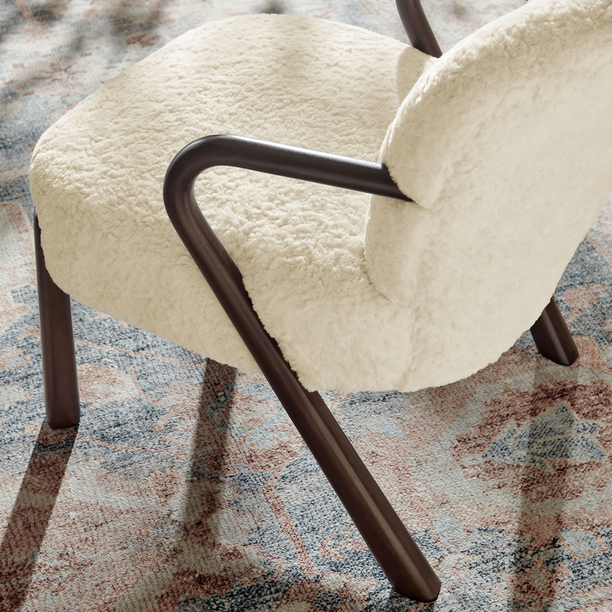 Soft teddy-like texture pairs with warm wood curves for a cozy, modern living room accent. || EEI-7489-ECR || detail_room