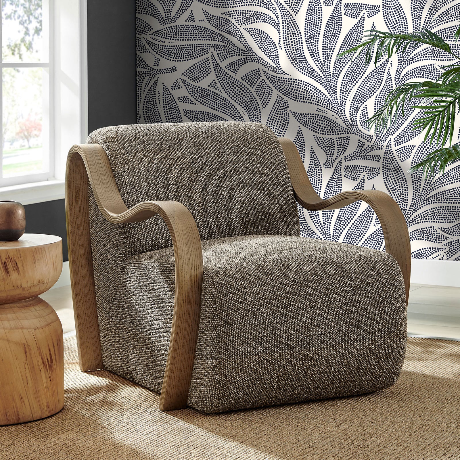 Statement lounge chair pairs curved wood arms with richly textured boucle for modern warmth. || EEI-7490-ETH || front_angle_room