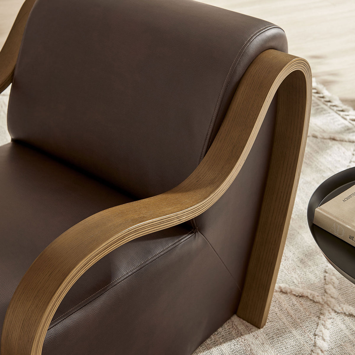 Sculpted bentwood arm showcases warm grain against rich espresso vegan leather upholstery || EEI-7491-ESP || detail_room