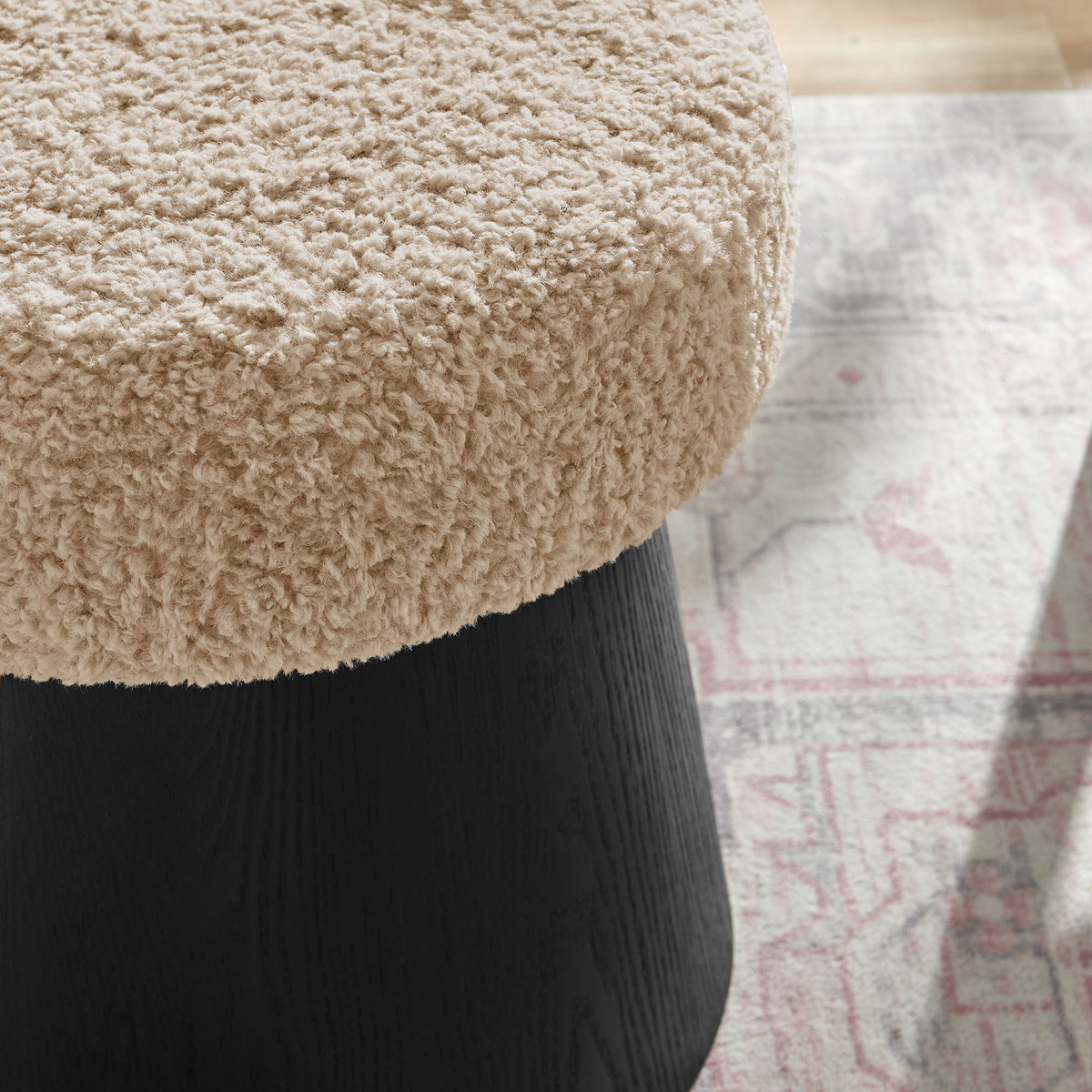 Faux shearling ottoman adds a cozy layer of texture alongside a patterned area rug || EEI-7493-OAT-BLK || detail_room