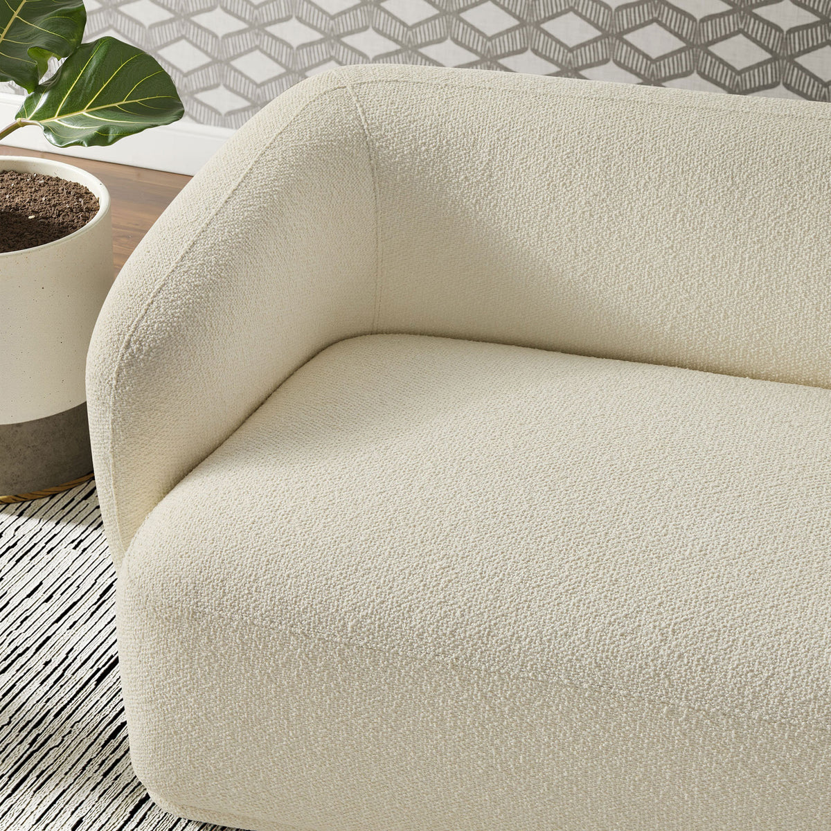 Boucle fabric and deep seat cushioning create a cozy spot on this cream Monica sofa || EEI-7501-CRE || detail_room