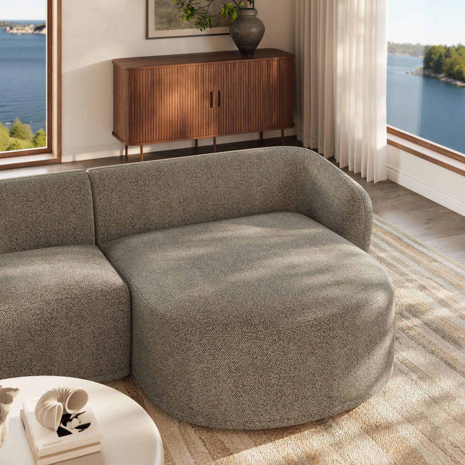 Right chaise in boucle fabric styled with sunlight, lake views, and warm wood accents for a serene space || EEI-7503-ETH || detail_room