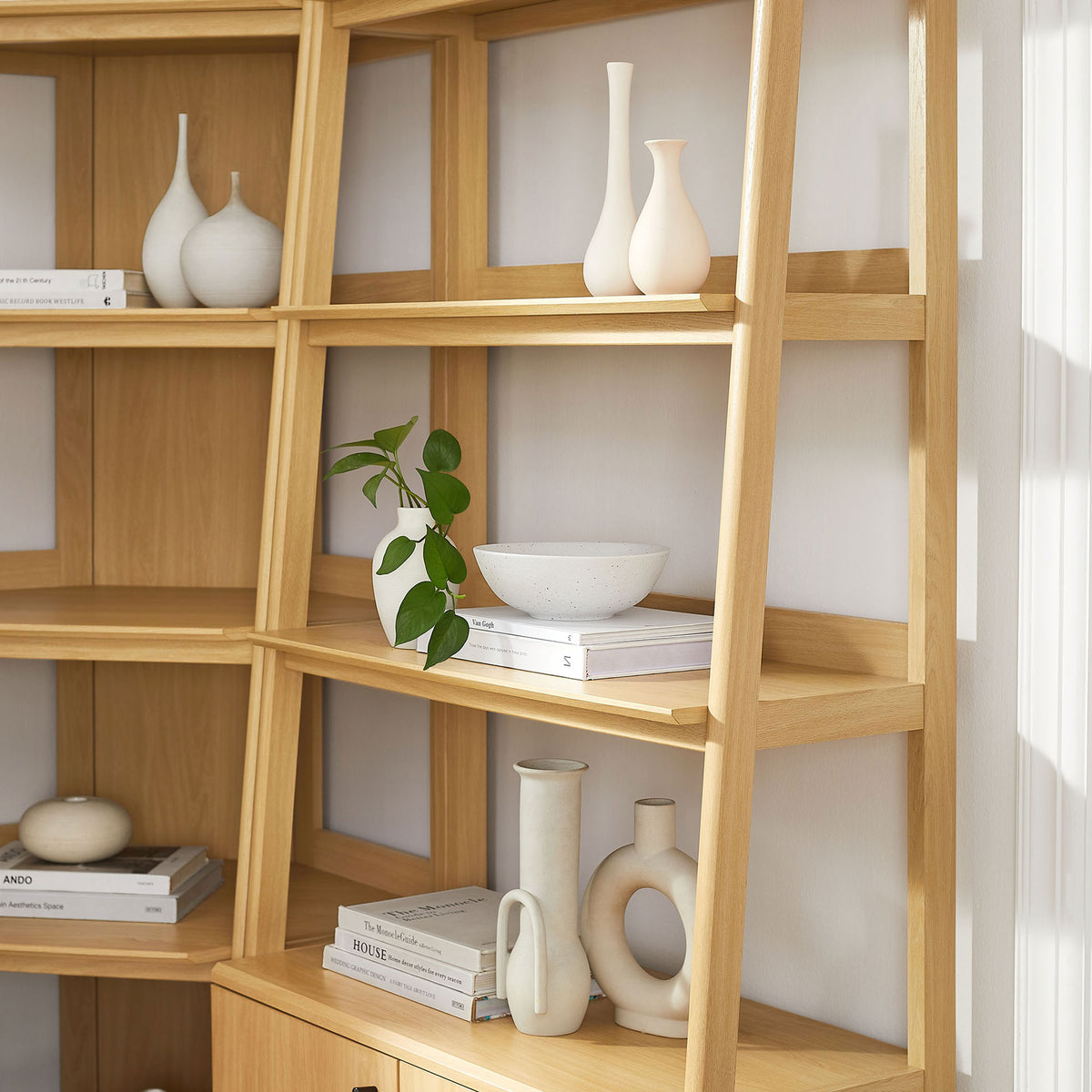 Sculptural supports and open shelves create a light, modern display for books and decor || EEI-7511-OAK || detail_room