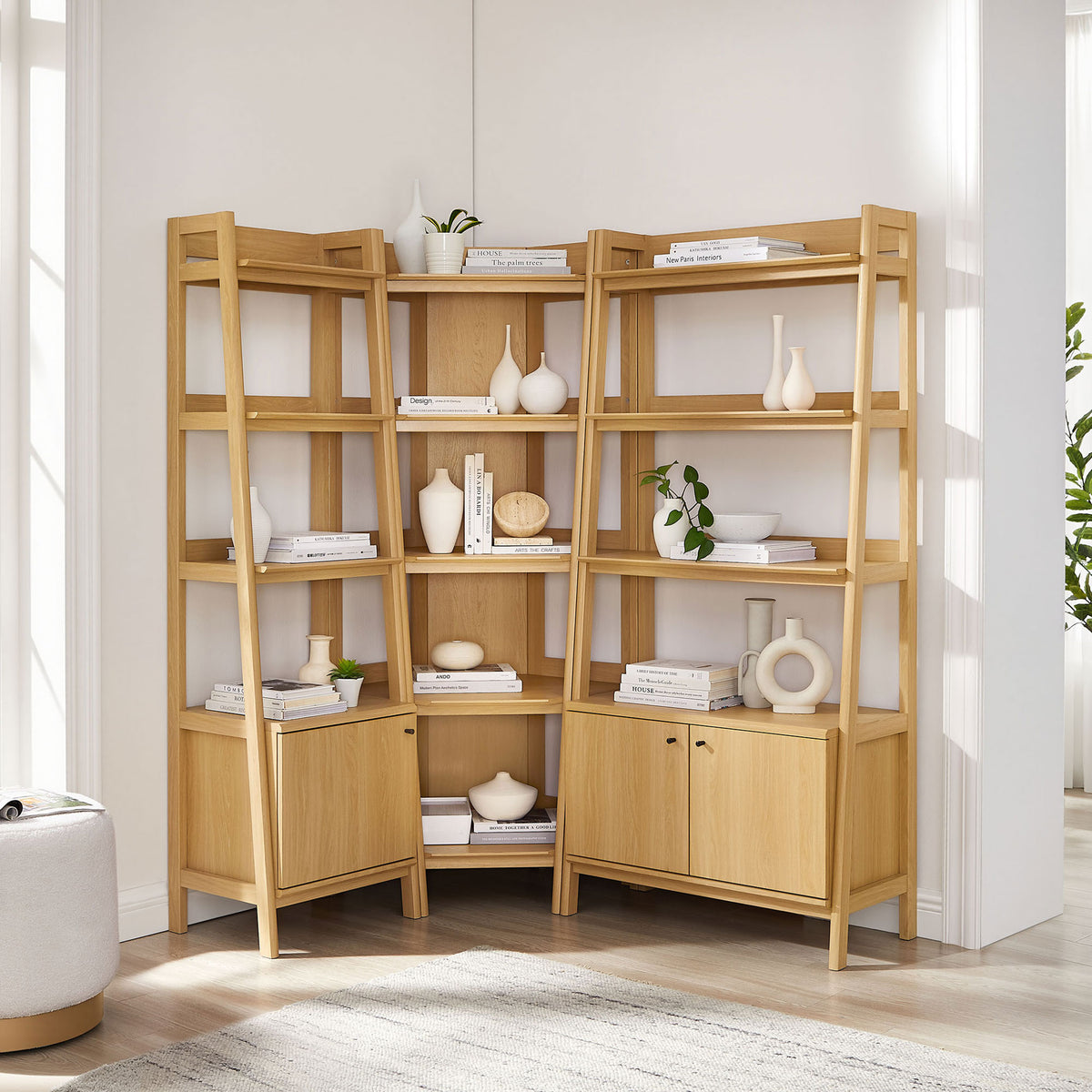 Contemporary oak corner bookshelf set with angled supports and lower cabinets for hidden storage || EEI-7511-OAK || front_angle_room