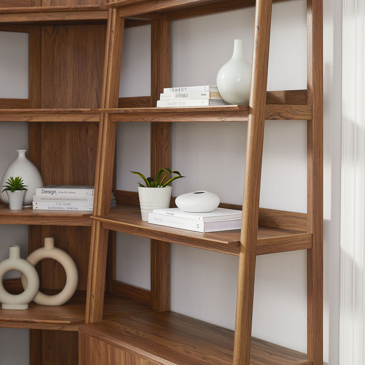 Styled shelves highlight the warm walnut finish and airy open design with clean lines || EEI-7511-WAL || detail_room