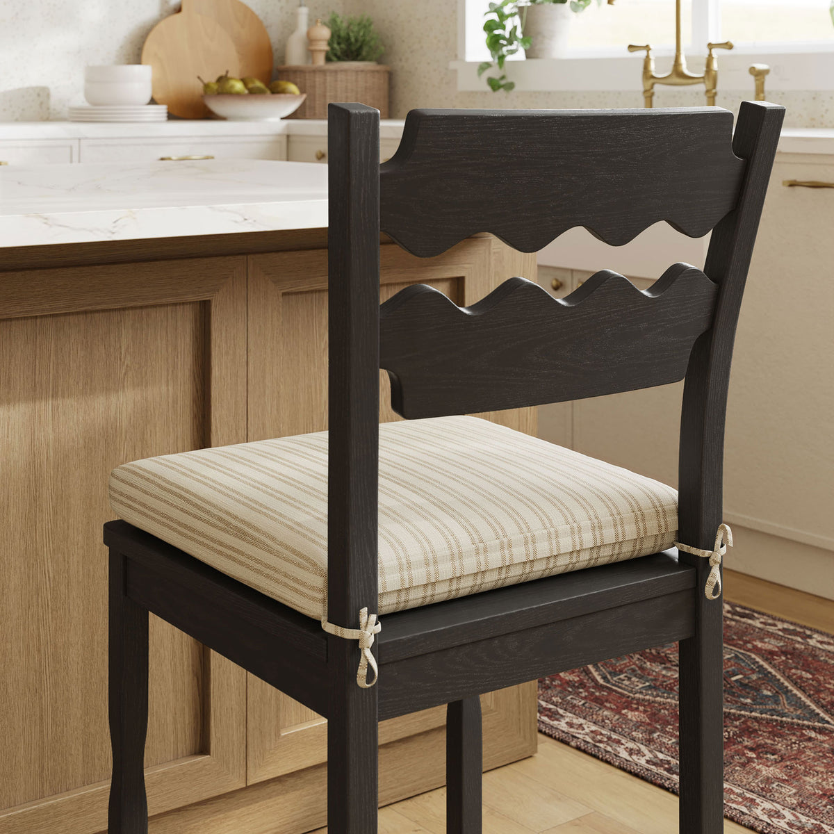 Cushion ties and rich wood grain add warmth in a cozy kitchen setting. || EEI-7518-BLK-OAS || detail_room