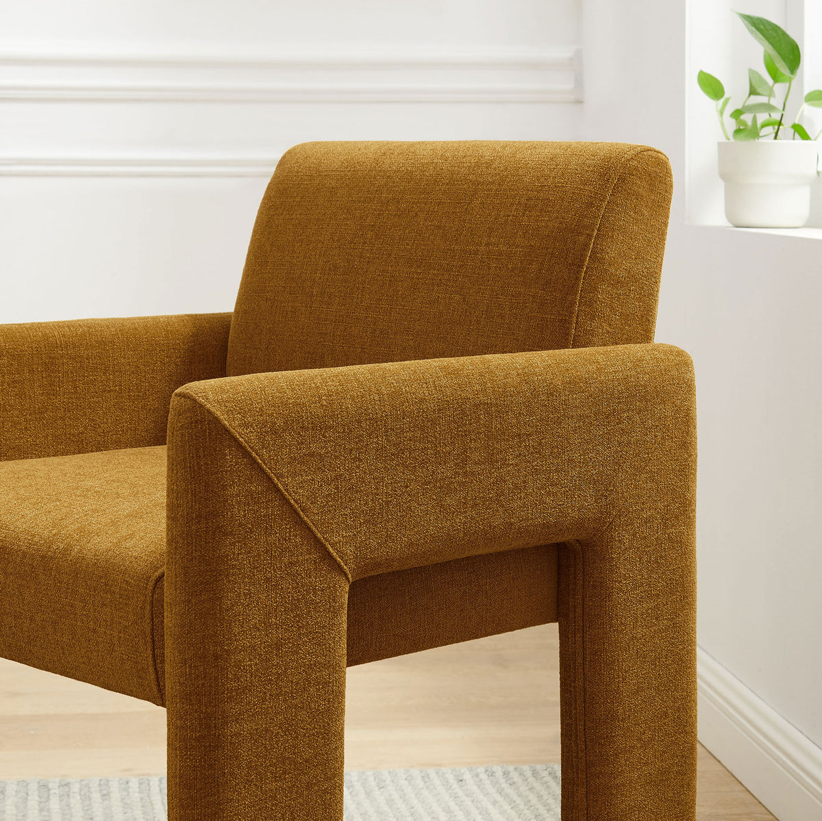 Copper upholstered dining chair bringing warm color and plush comfort to a bright, airy room || EEI-7524-COP || detail_room