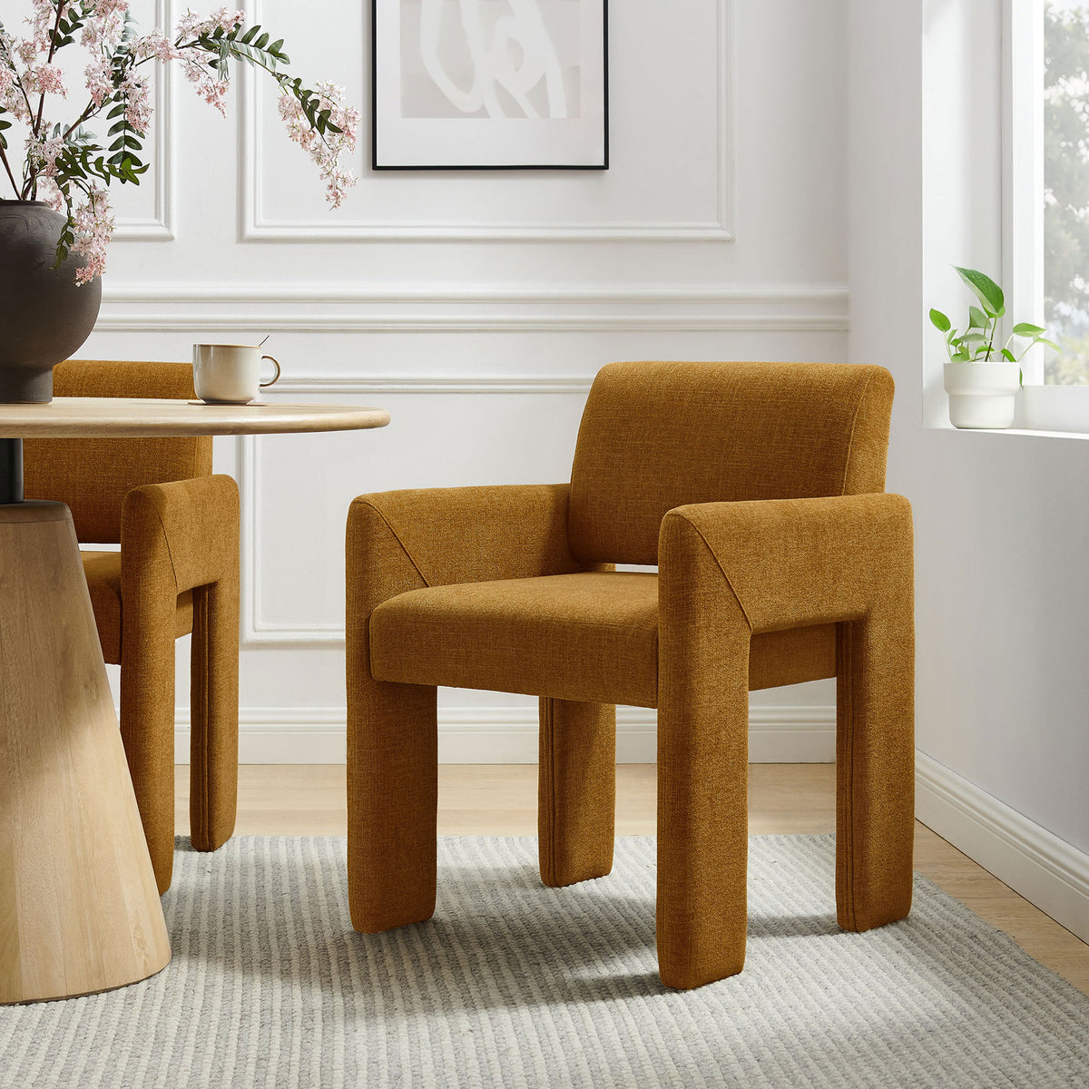 Copper upholstered dining chair styled with a round wood table to create a cozy modern dining nook || EEI-7524-COP || front_angle_room