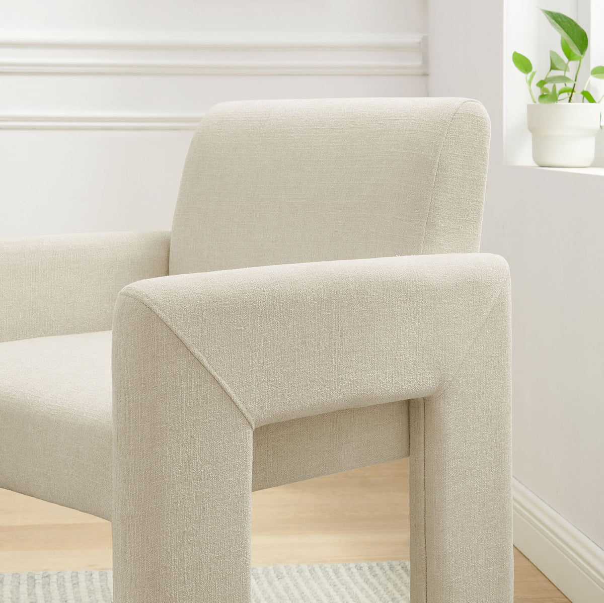 Ecru Daven armchair styled in a bright dining nook, highlighting its plush back cushion and slim arms || EEI-7524-ECR || detail_room