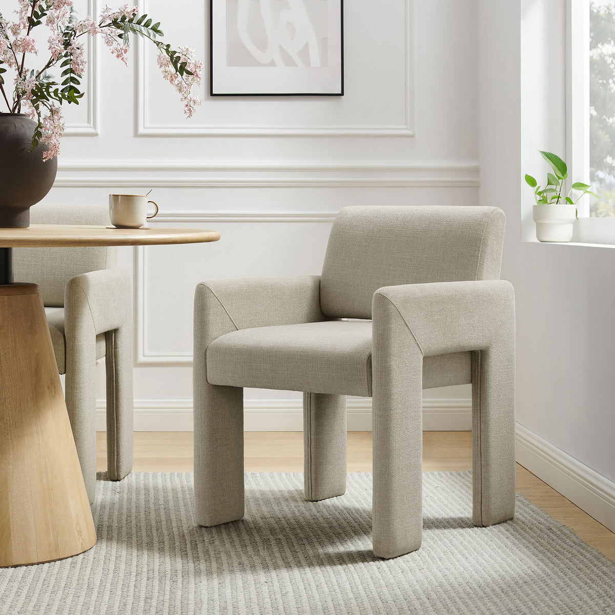 Daven linen upholstered dining chair paired with a modern wood table to create an airy, contemporary dining nook || EEI-7524-LIN || front_angle_room