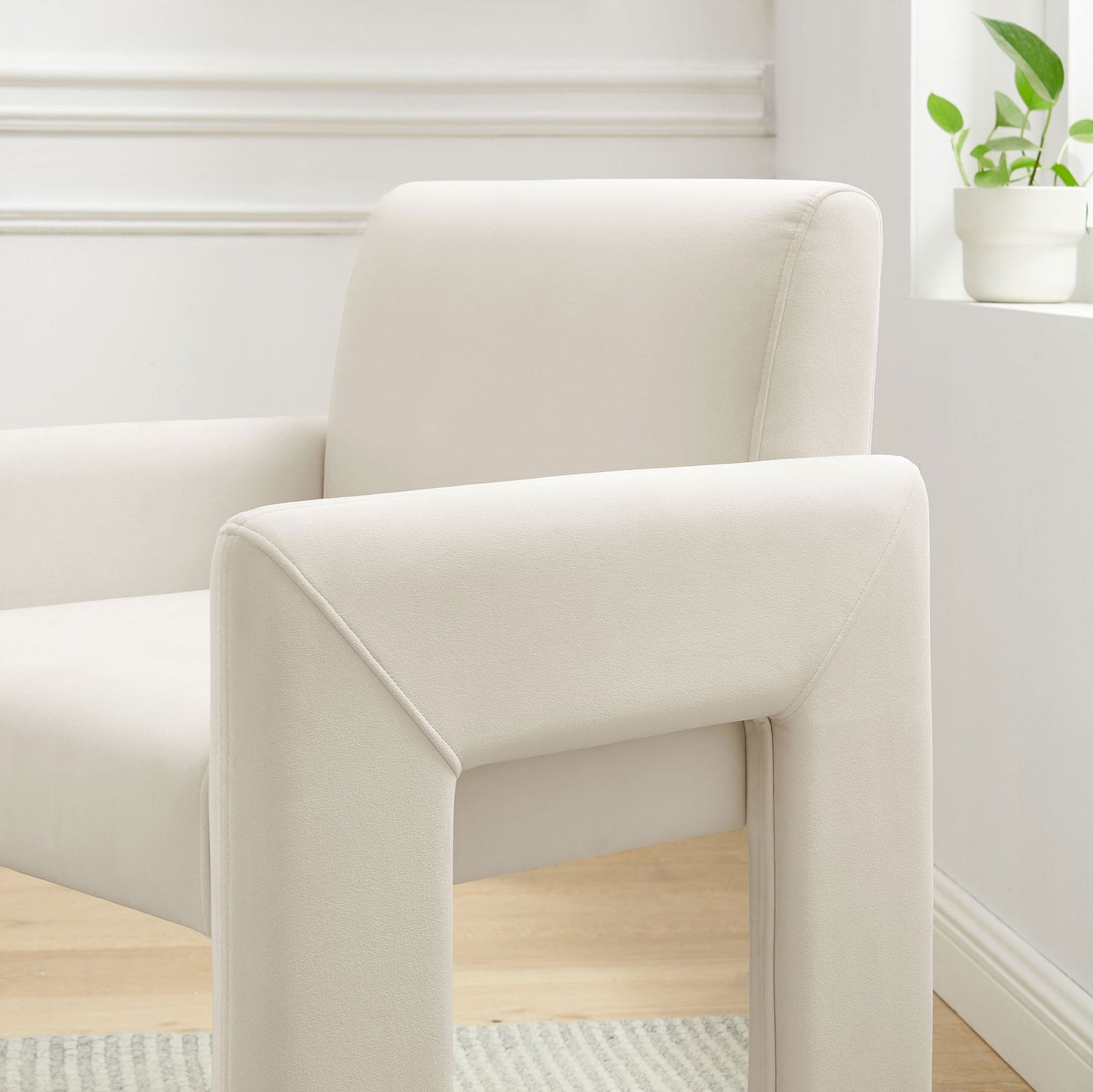 Alabaster velvet dining armchair brightening a modern nook with soft curves and clean architectural lines || EEI-7525-ALA || front_angle_room