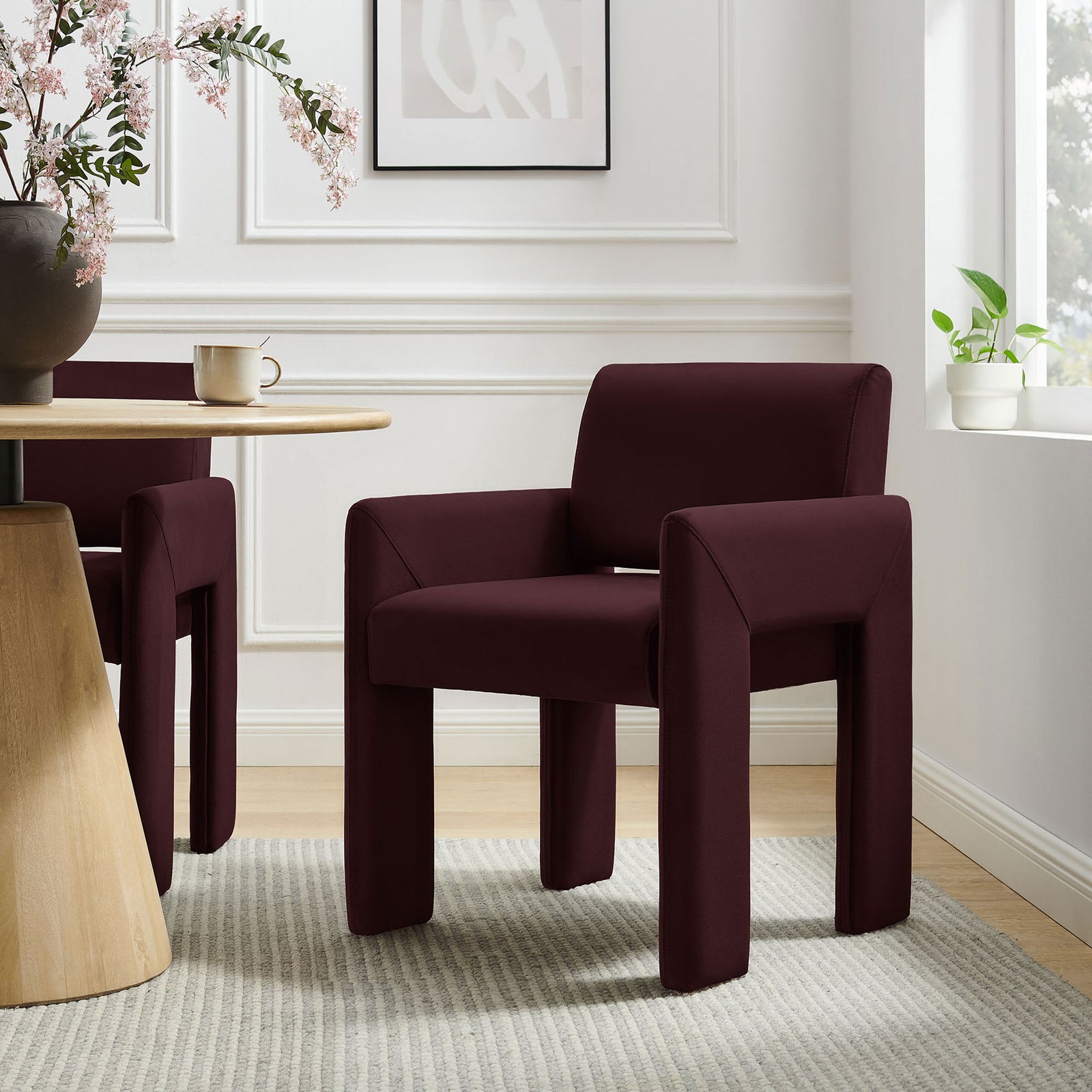 Mulberry velvet dining armchair paired with a modern round table in an airy white dining room || EEI-7525-MUL || front_angle_room