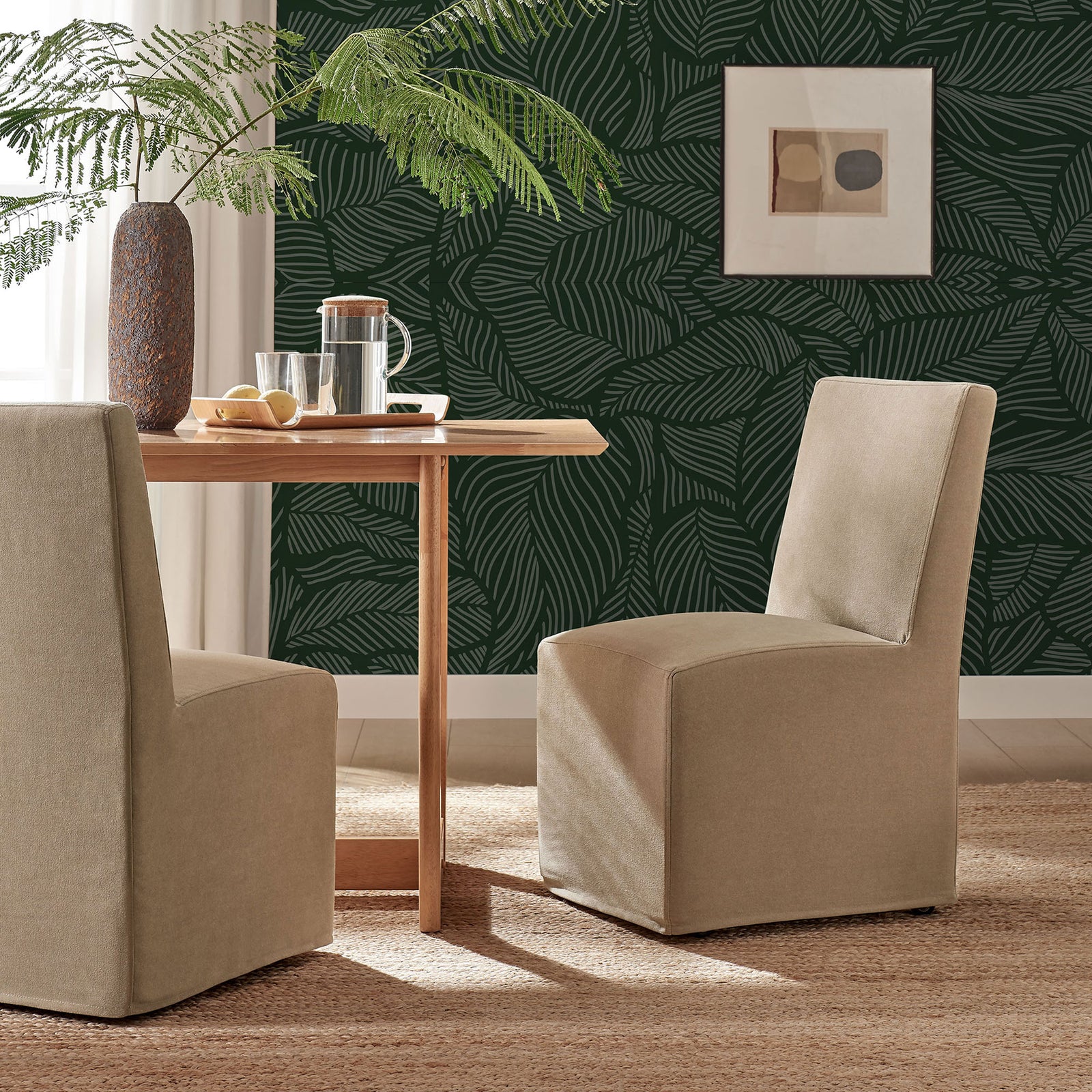 Pair of almond slipcovered dining chairs create a warm, casual gathering spot around a wood table || EEI-7528-ALM || front_angle_room