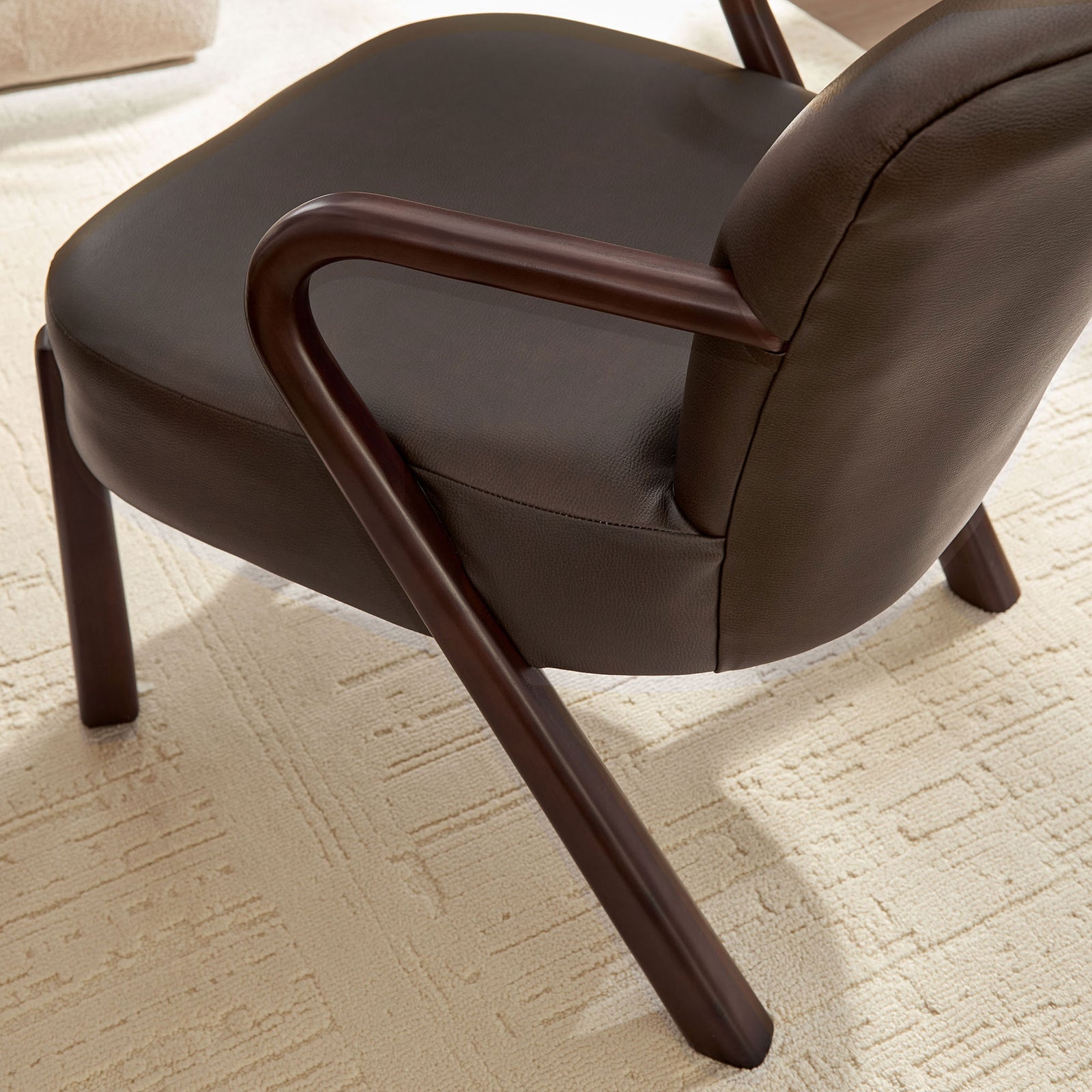Sculptural wood arm contours add organic warmth against smooth espresso upholstery || EEI-7529-ESP || detail_room